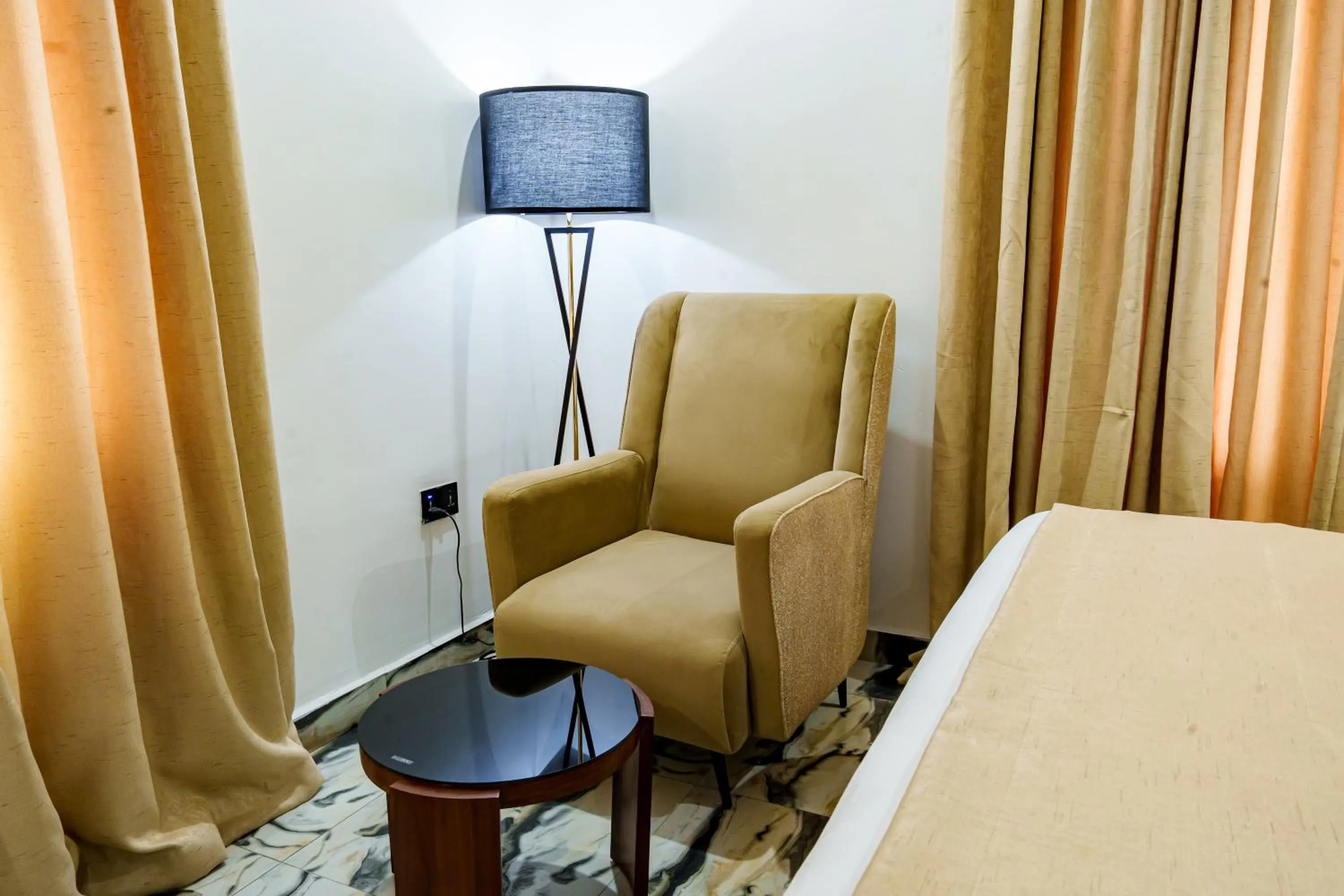 Seating area, Bed in Roston Hotels