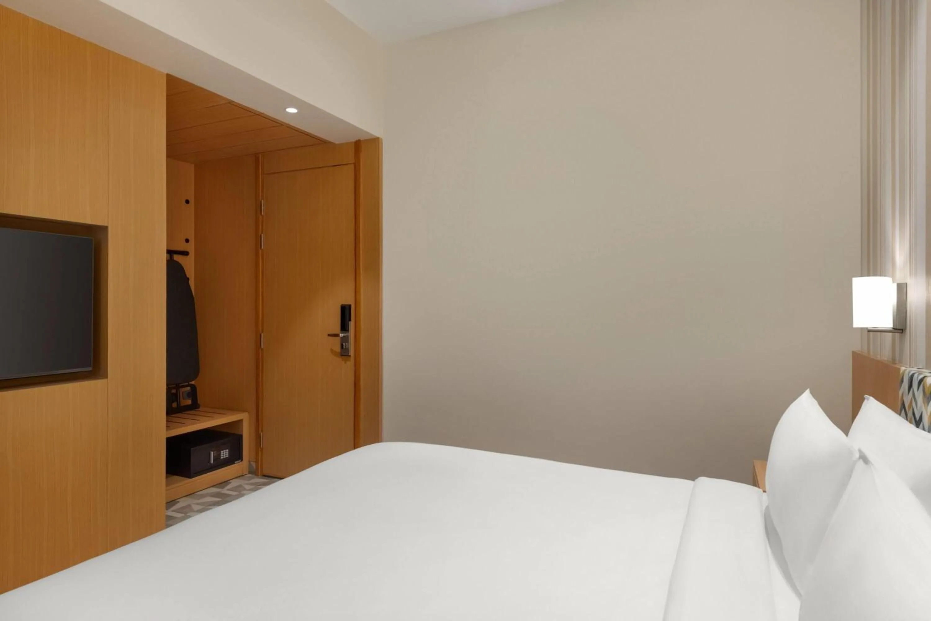 Photo of the whole room, Bed in Ramada Encore by Wyndham Lucknow Airport