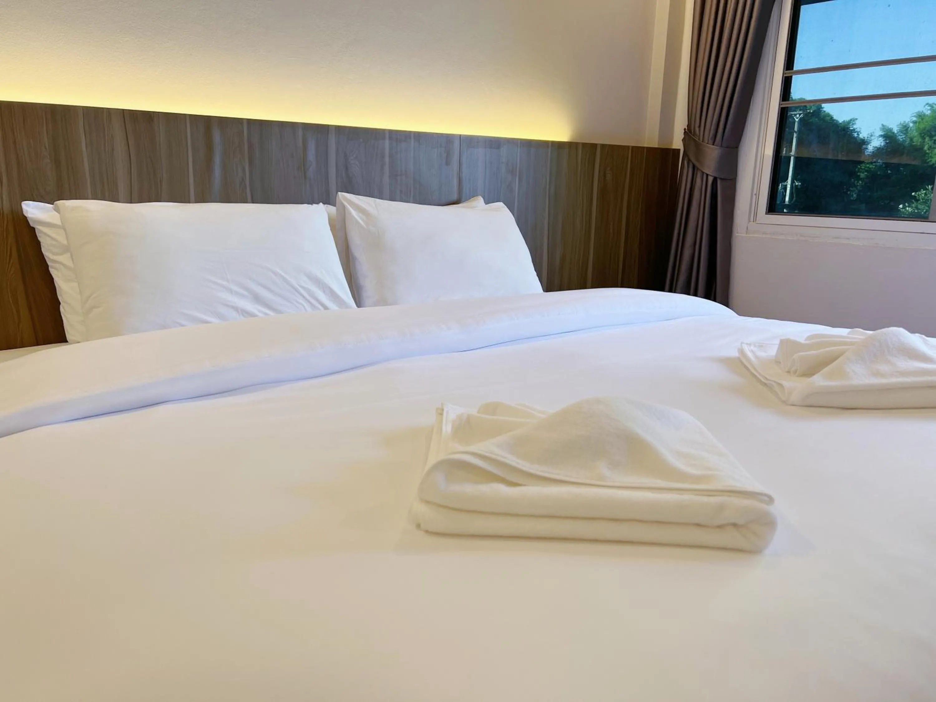 Bed in The Space Airport Hotel Chiang Rai