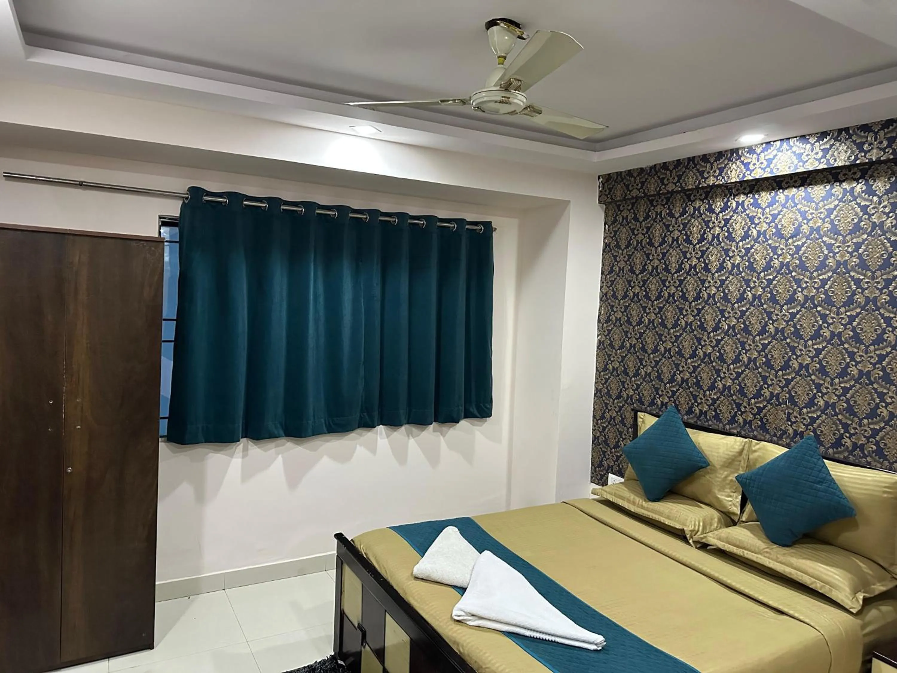 Bed in Blue Bliss Suites By PPH Living