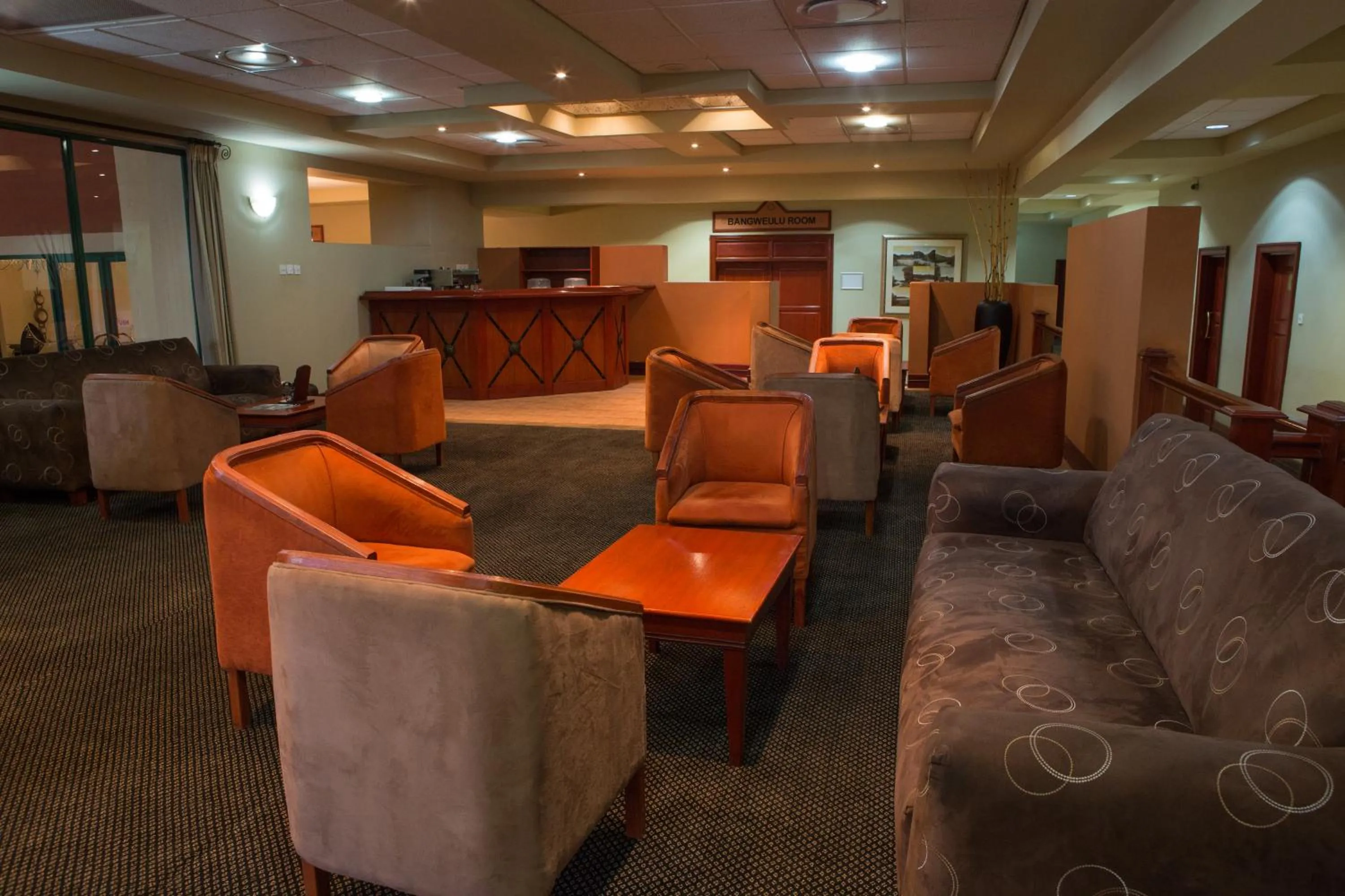 Communal lounge/ TV room in M'kango Golfview Hotel