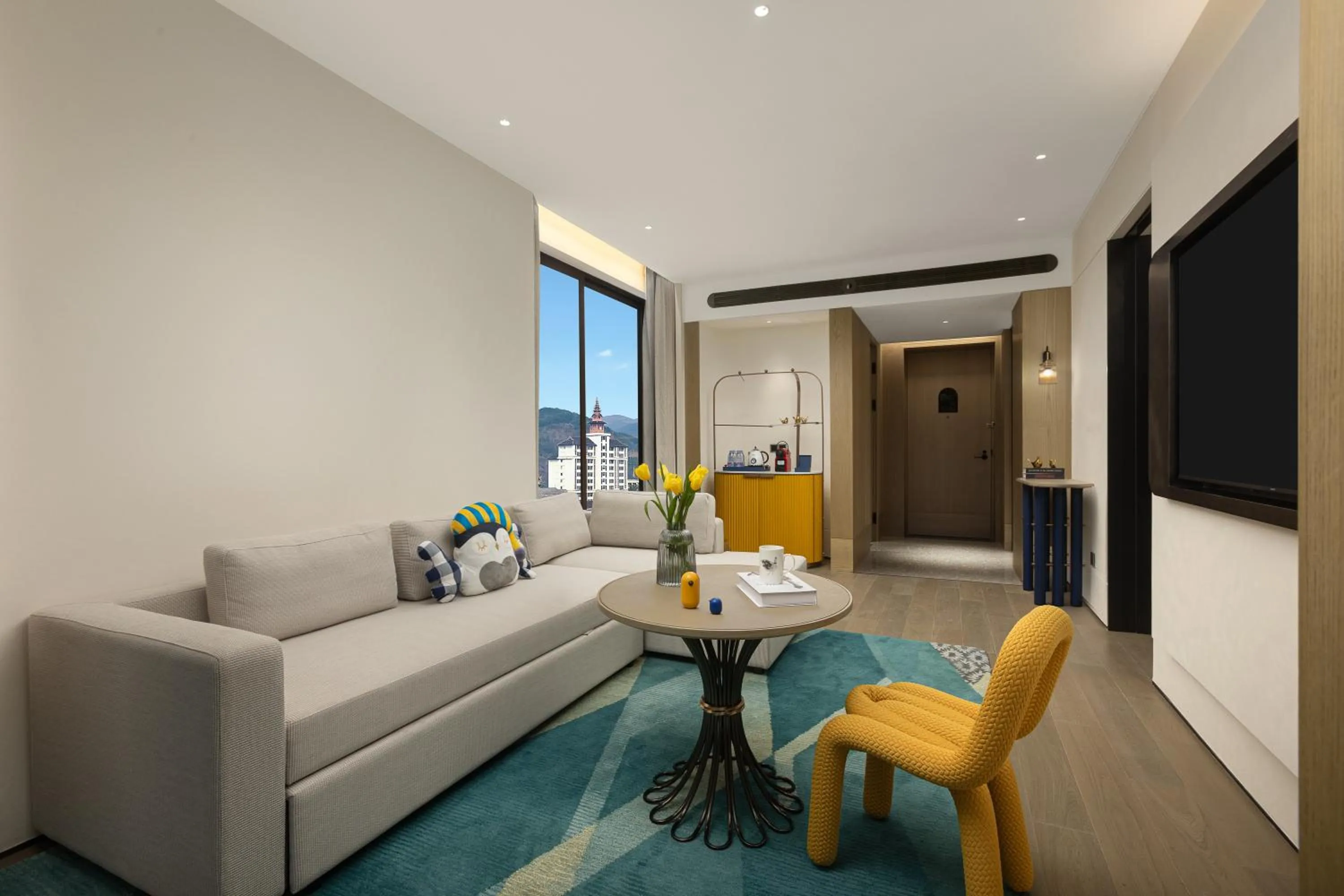 Living room in voco Xishuangbanna Gaozhuang by IHG