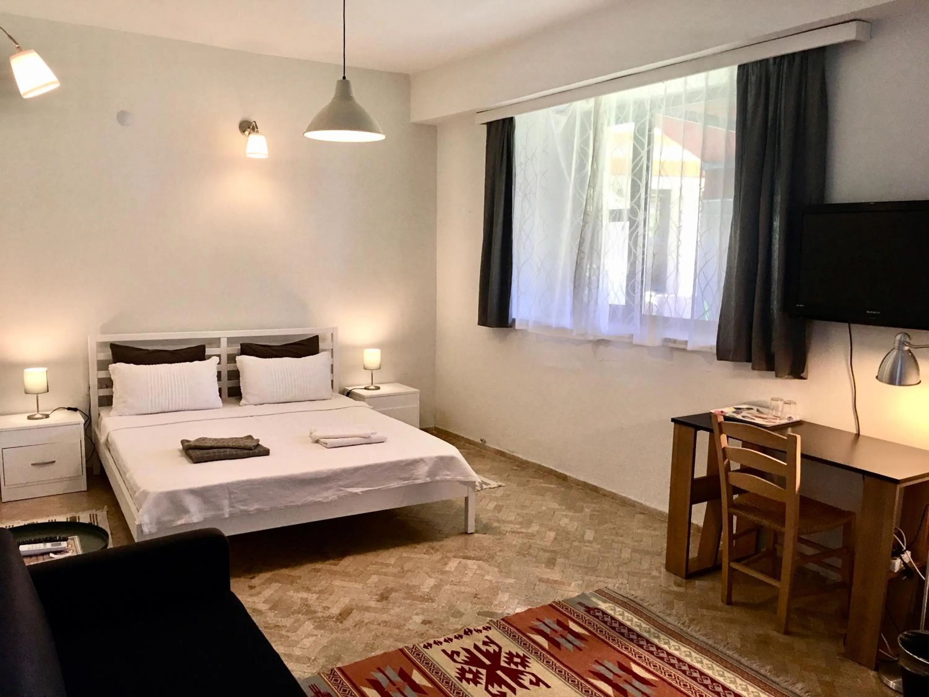 Bed in Attalos Suites Hotel