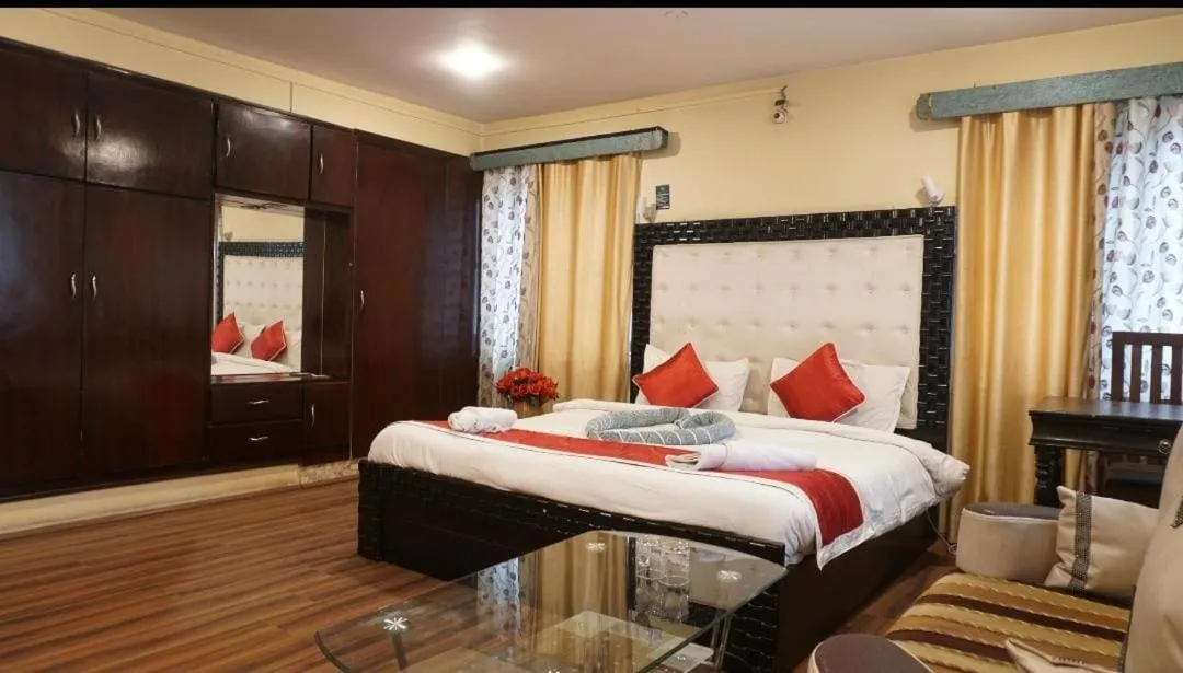 Bed in Heavenwood Heritage Hotel By Urban Inn Resorts