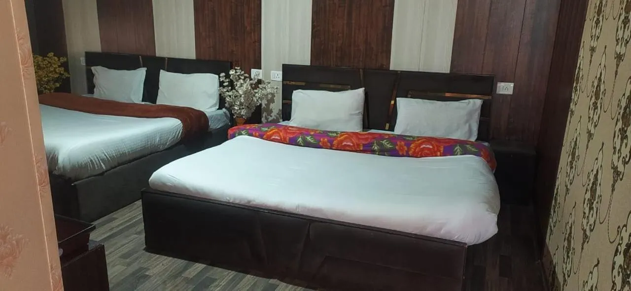 Bed in Heavenwood Heritage Hotel By Urban Inn Resorts