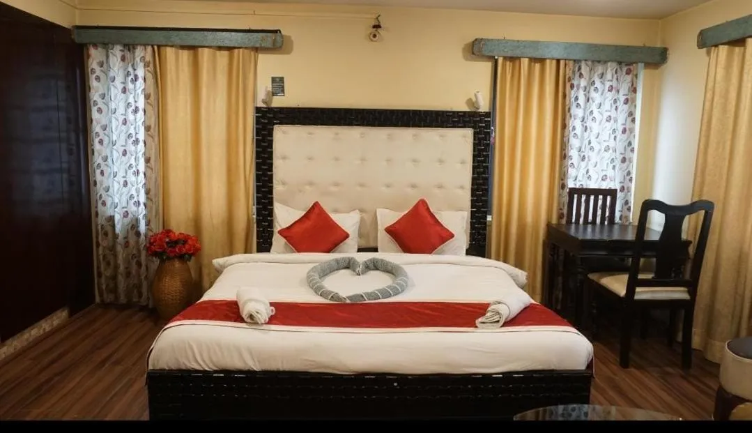 Bed in Heavenwood Heritage Hotel By Urban Inn Resorts