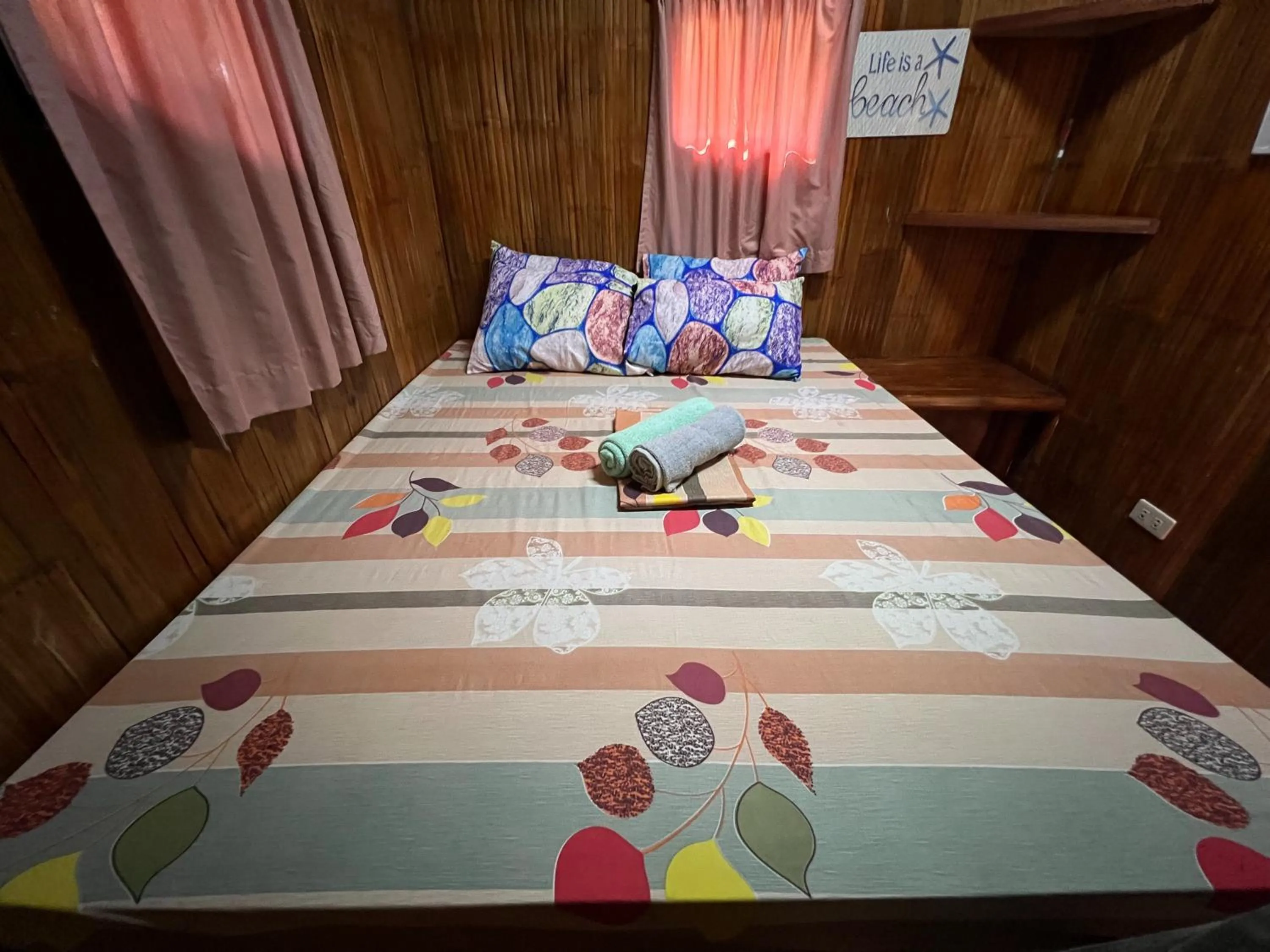 Bed in Lumiere Beachfront Resort