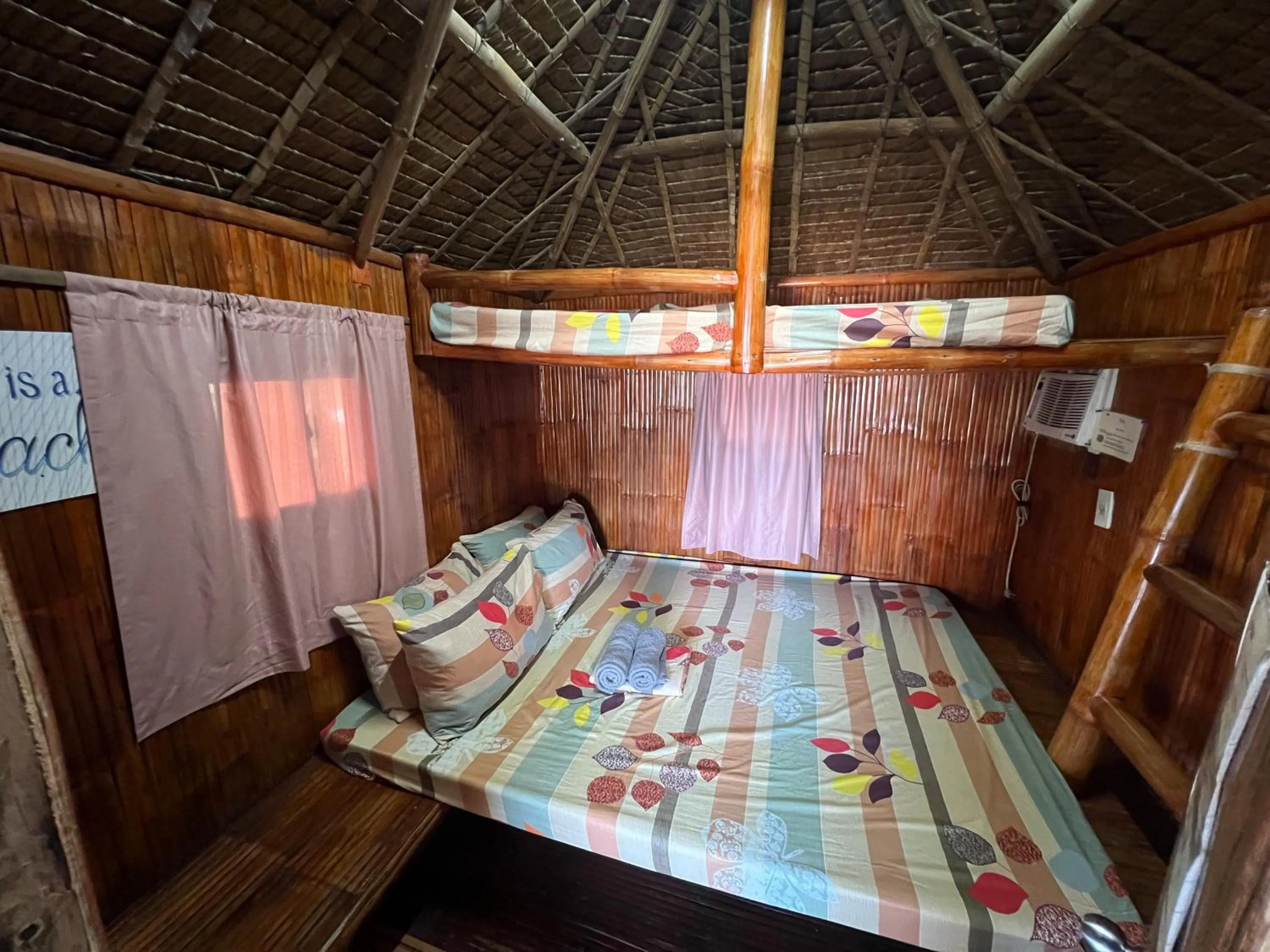 Bed in Lumiere Beachfront Resort