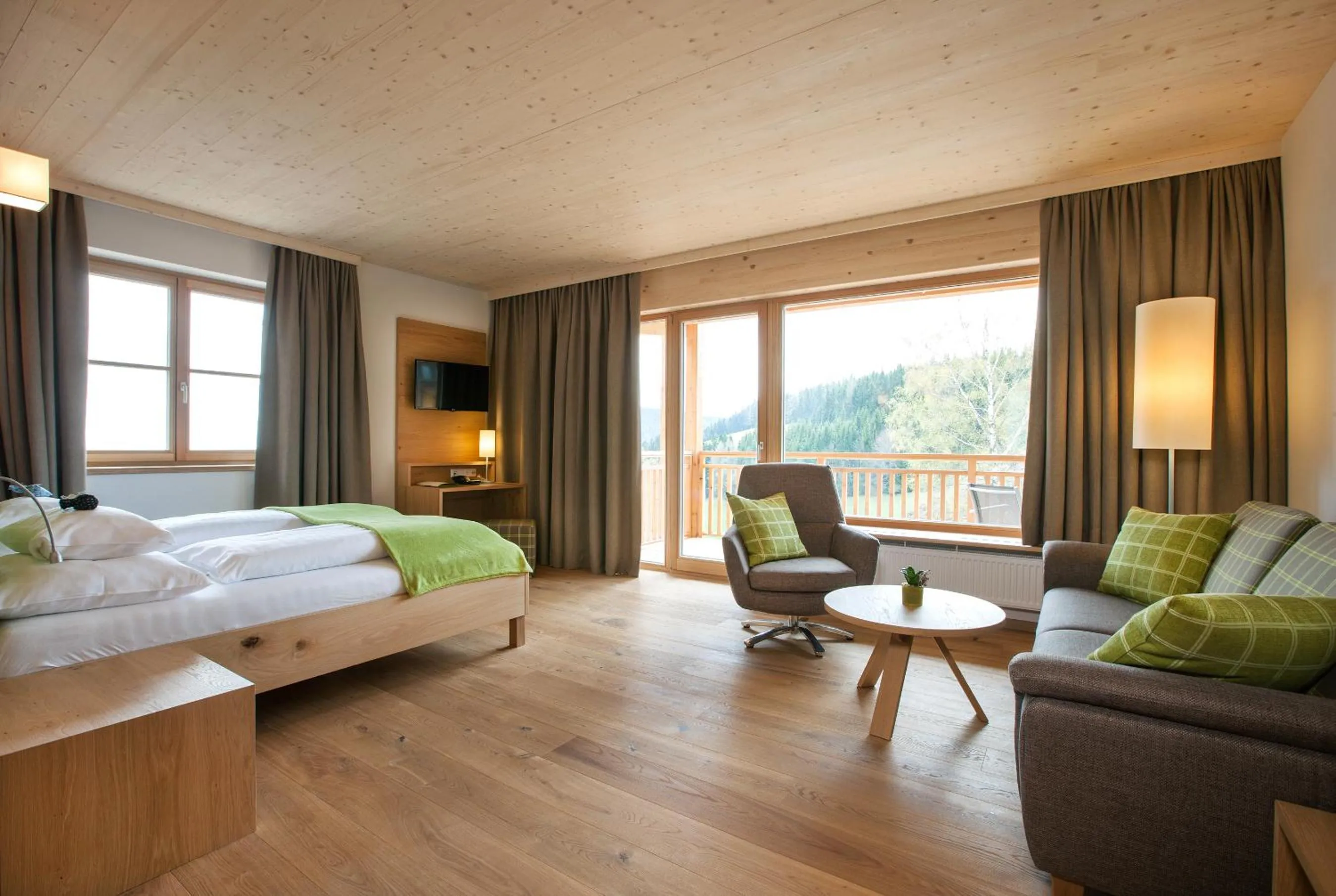 Living room, Bed in Naturhotel Bauernhofer