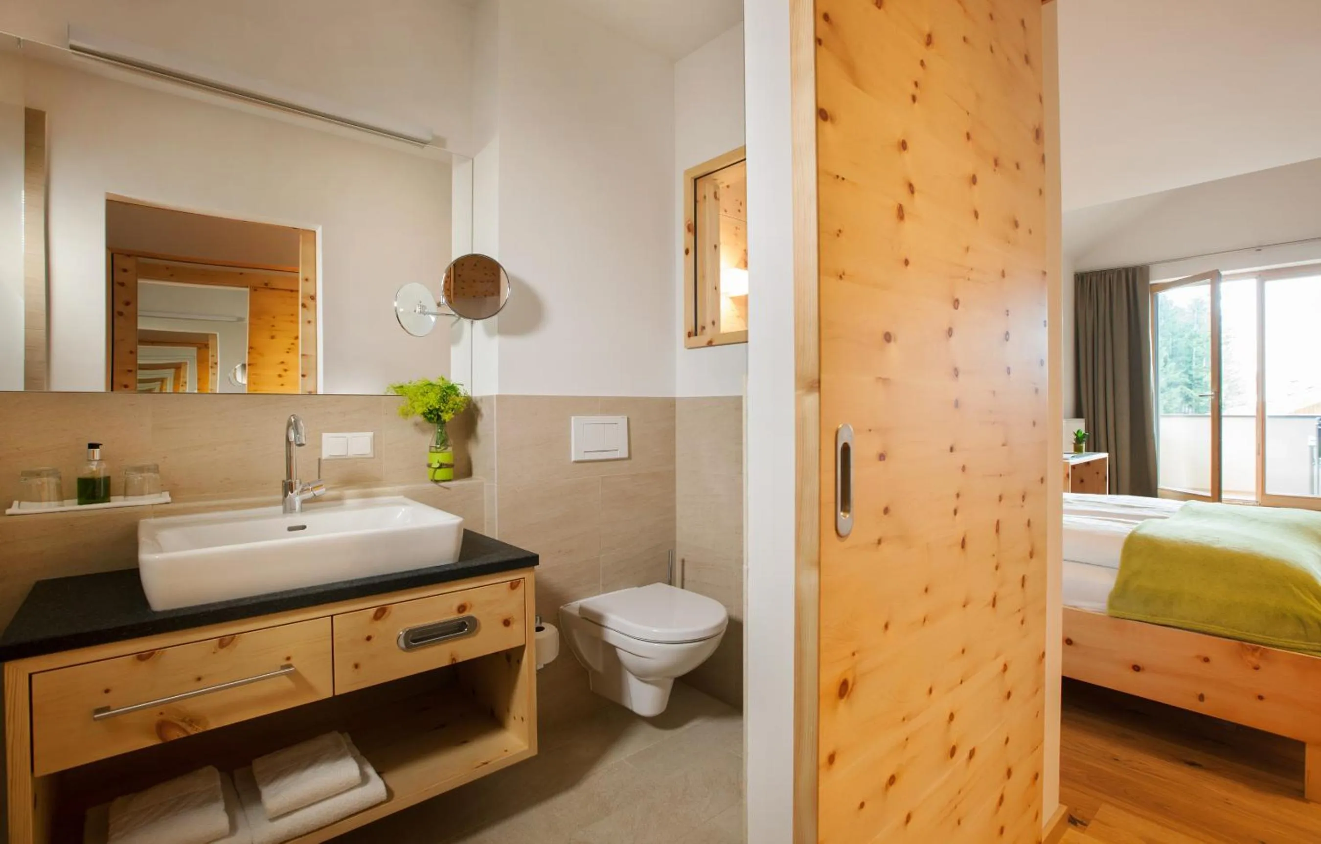 Bathroom, Bed in Naturhotel Bauernhofer