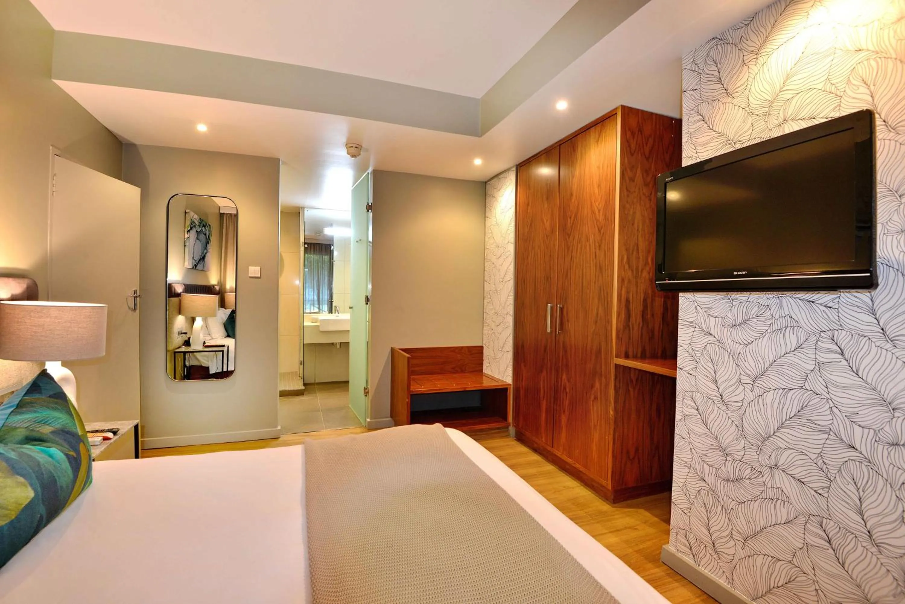 Communal lounge/ TV room, Bed in Cresta Lodge Harare