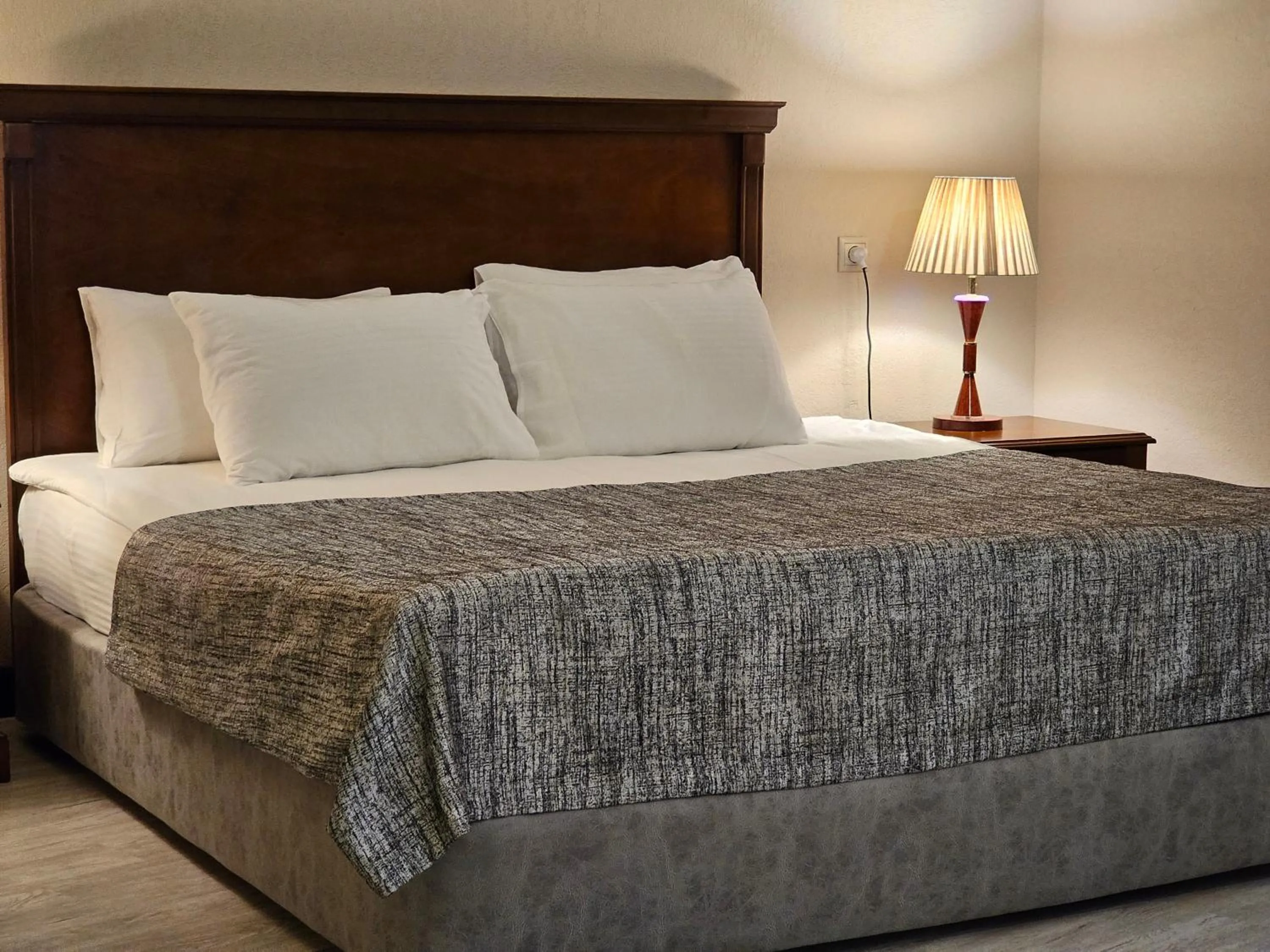 Bed in Crown Suites Hotel