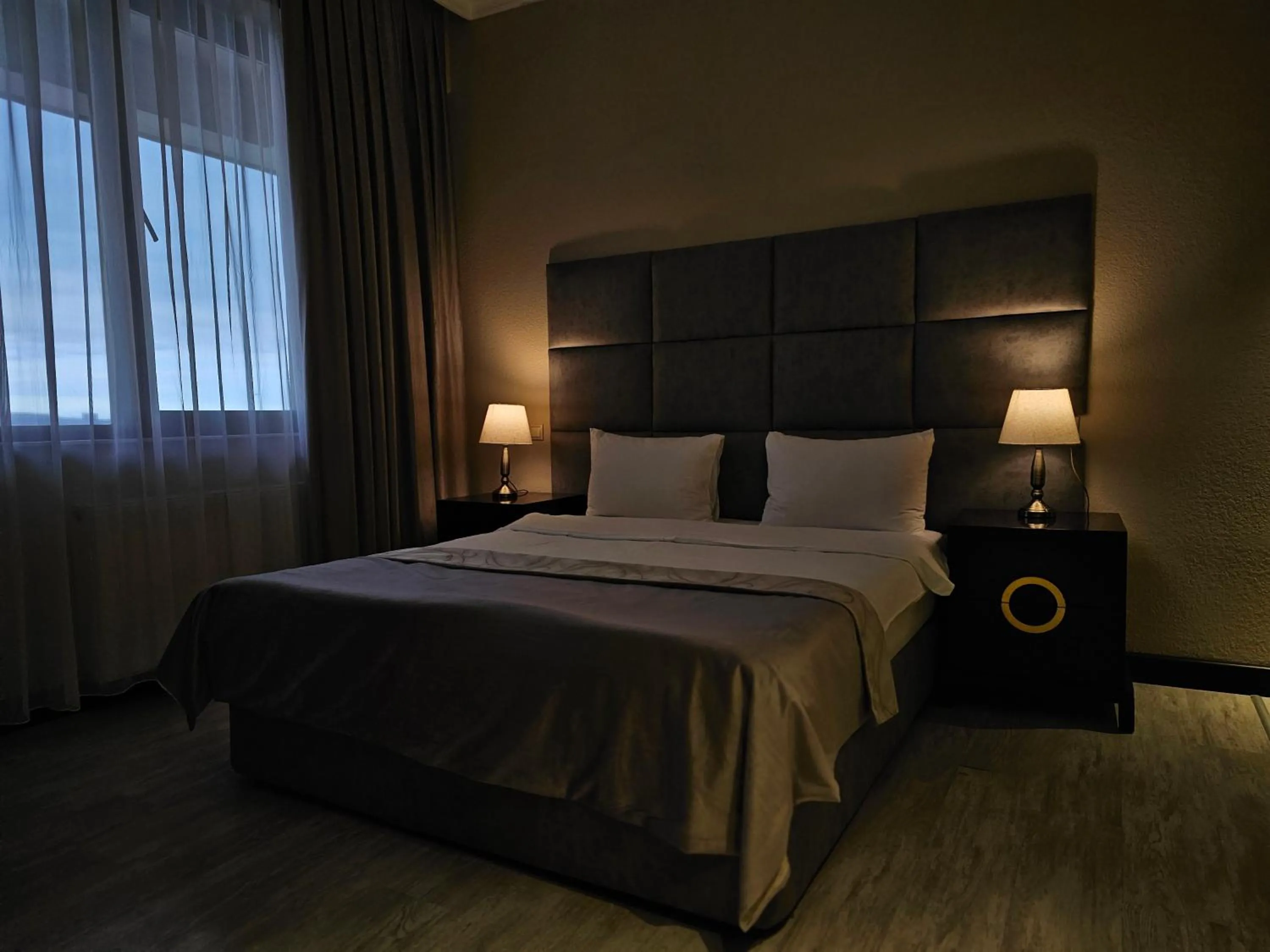 Bed in Crown Suites Hotel