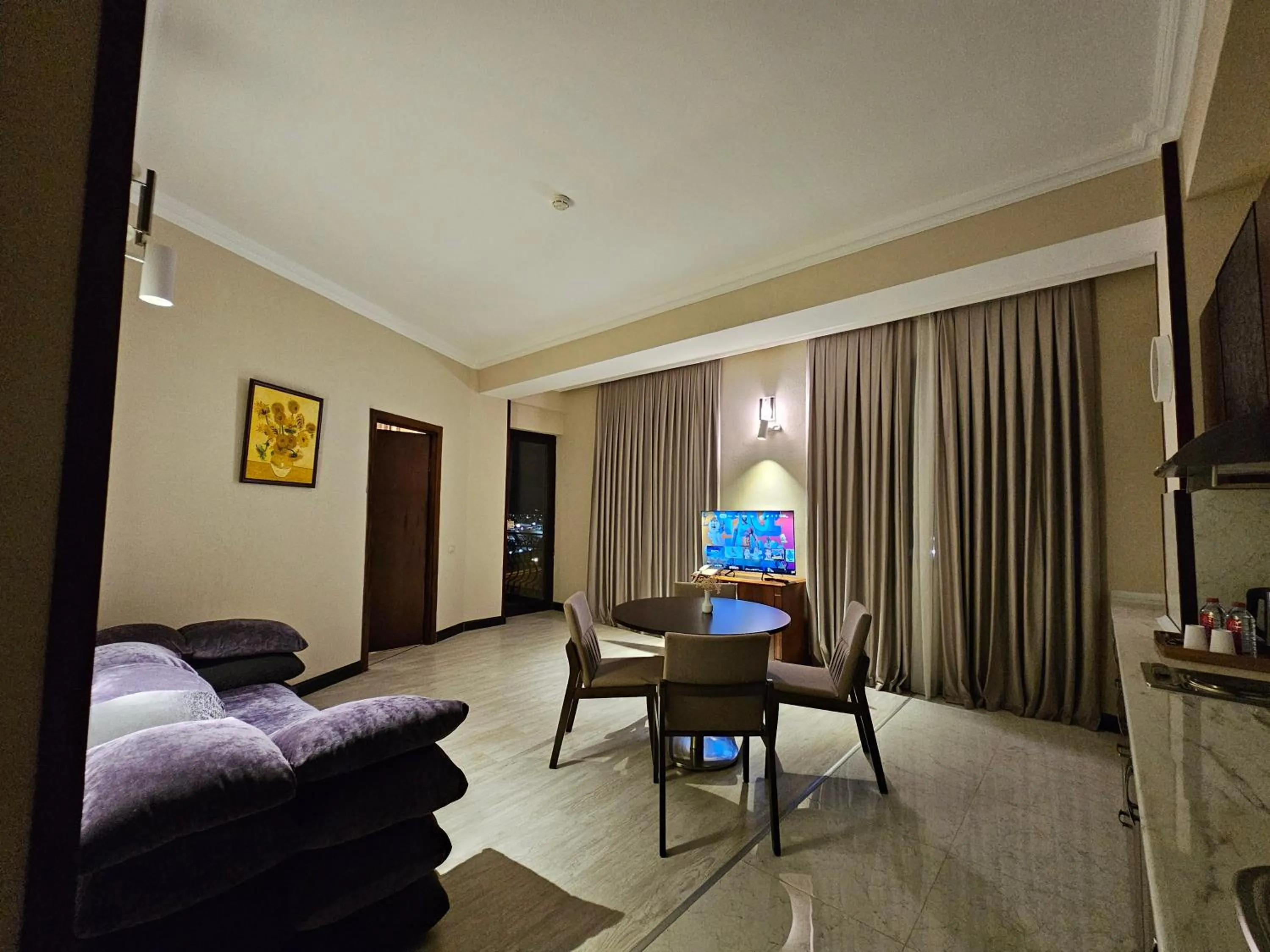 Communal lounge/ TV room in Crown Suites Hotel