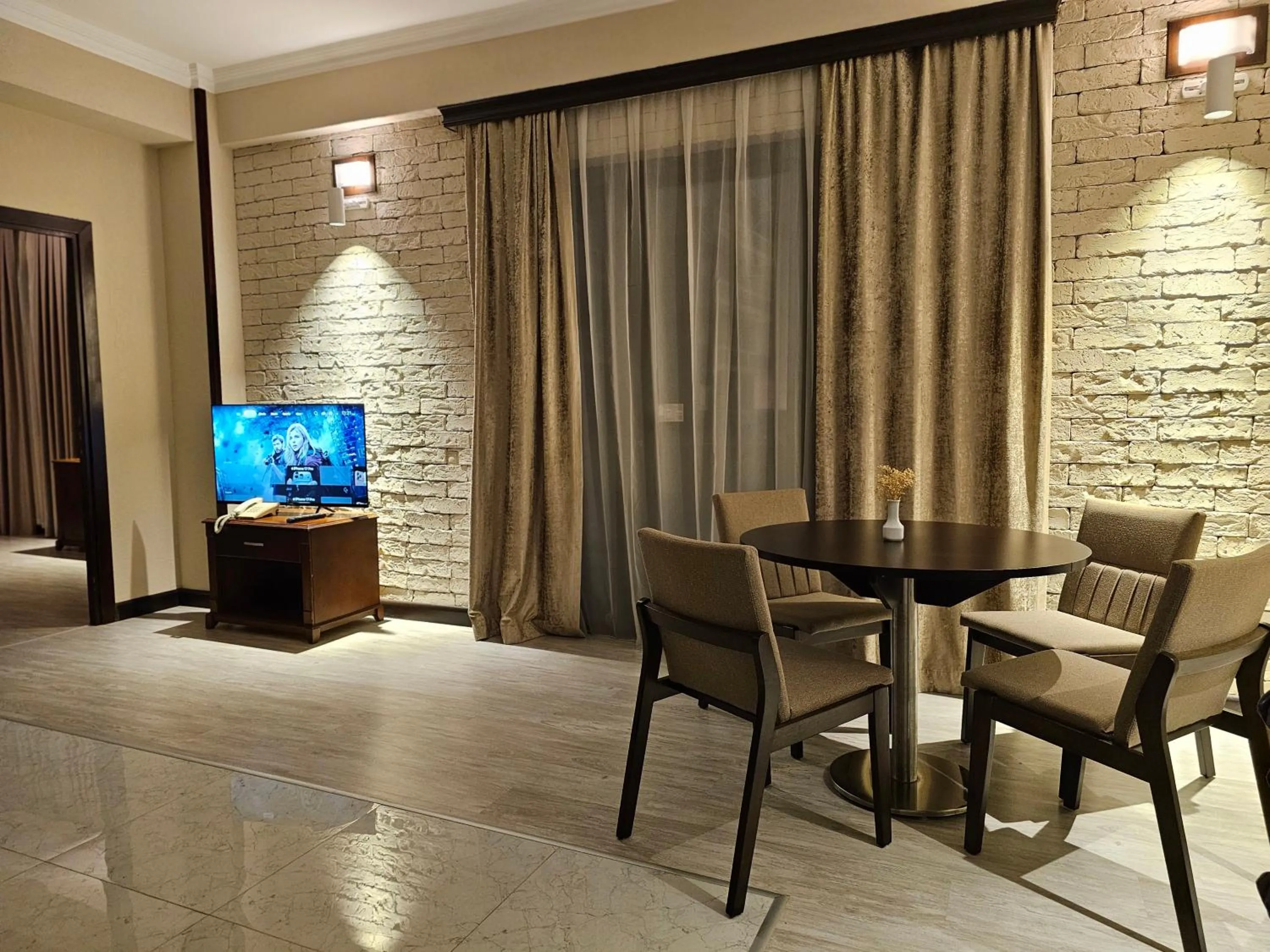 Communal lounge/ TV room in Crown Suites Hotel