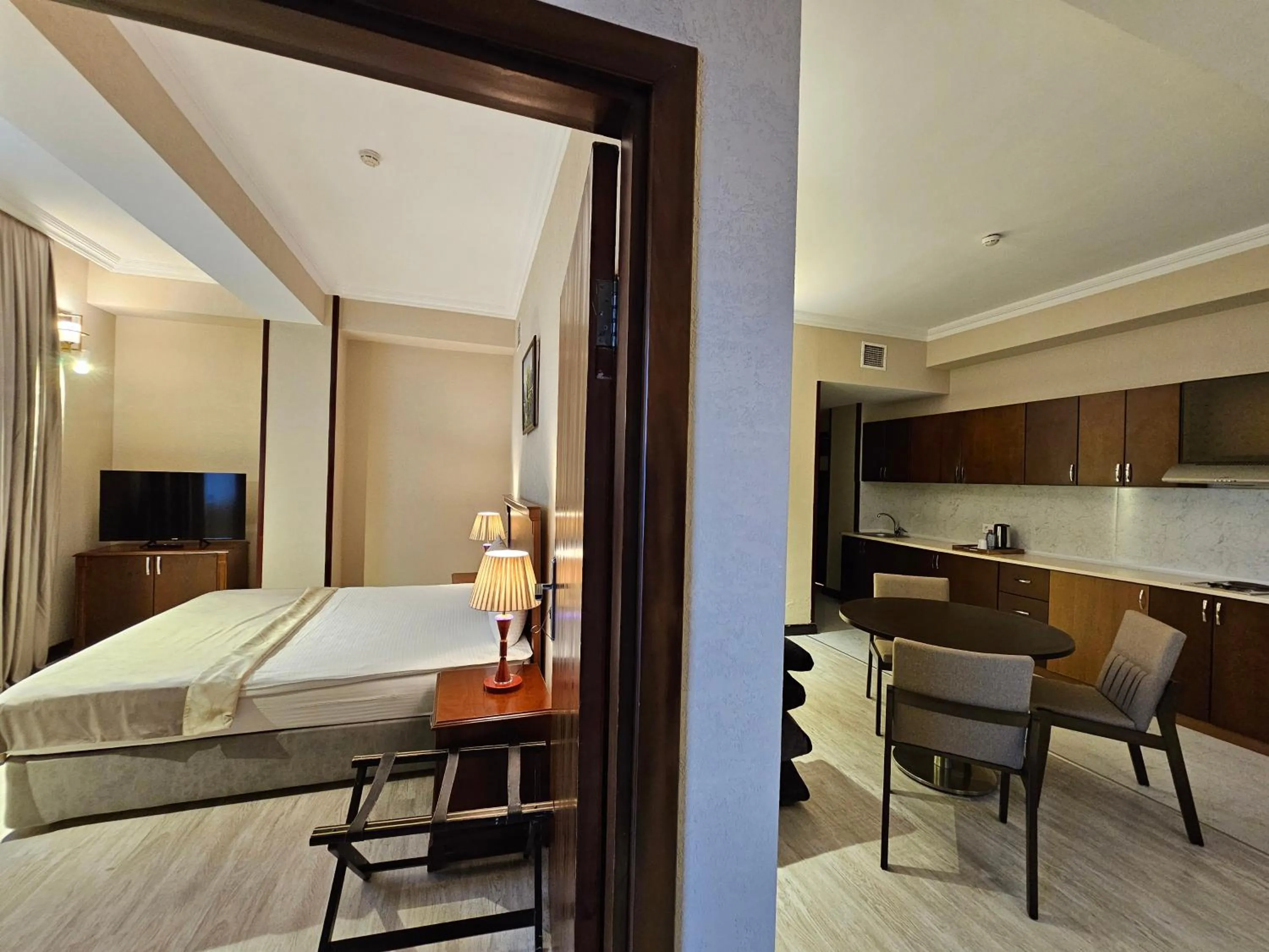 Communal lounge/ TV room, Bed in Crown Suites Hotel