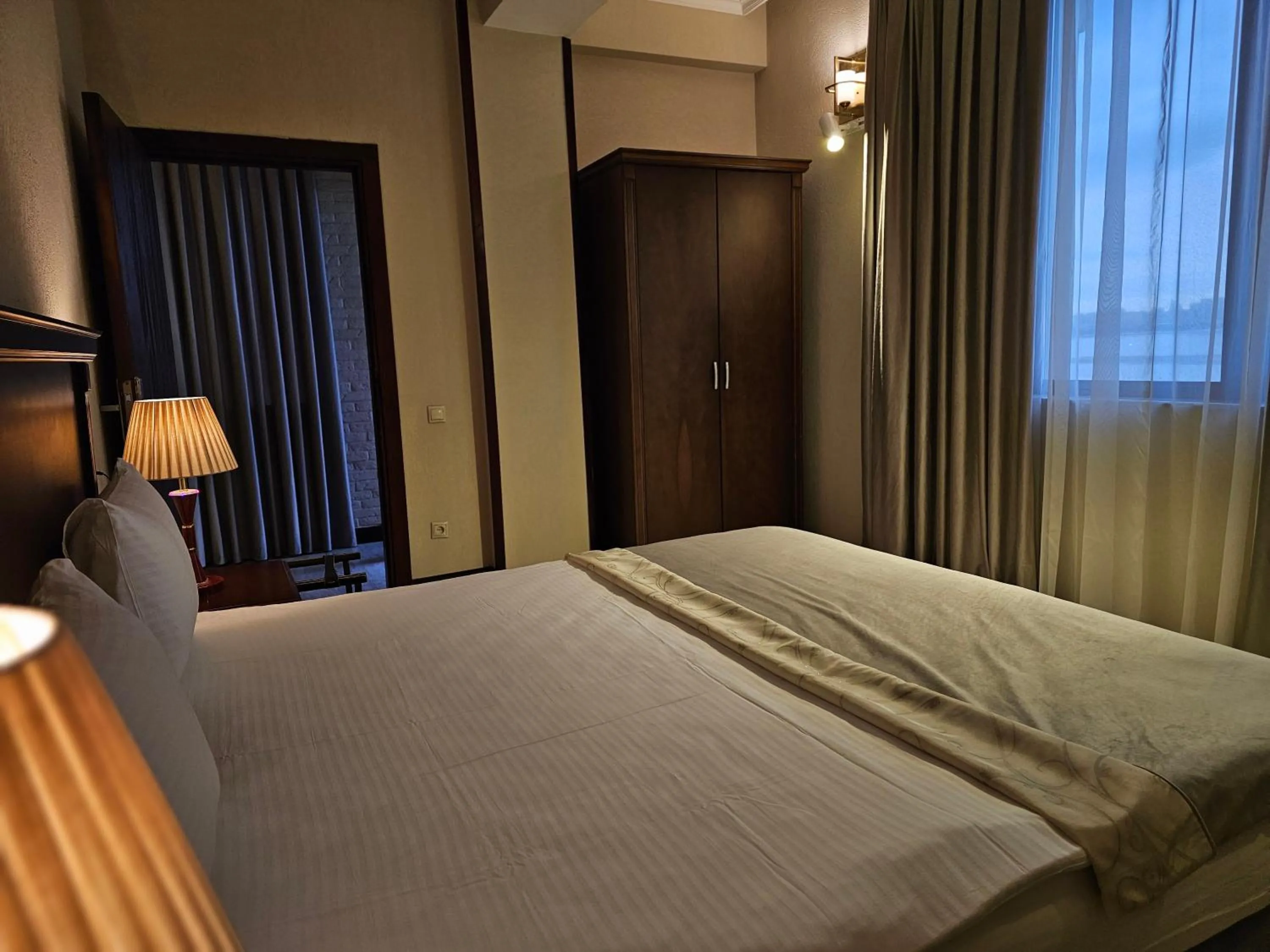 Bed in Crown Suites Hotel