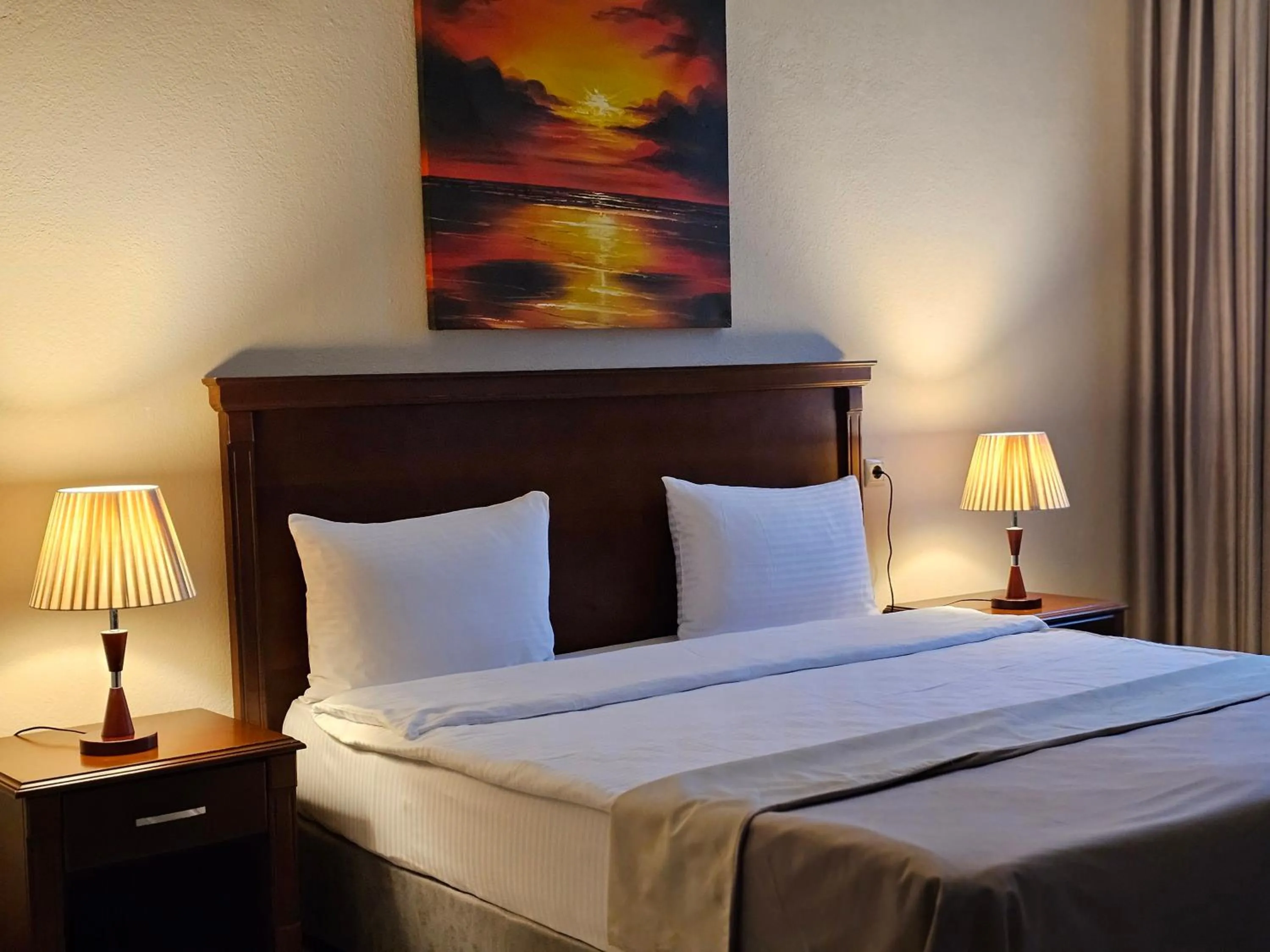 Bed in Crown Suites Hotel
