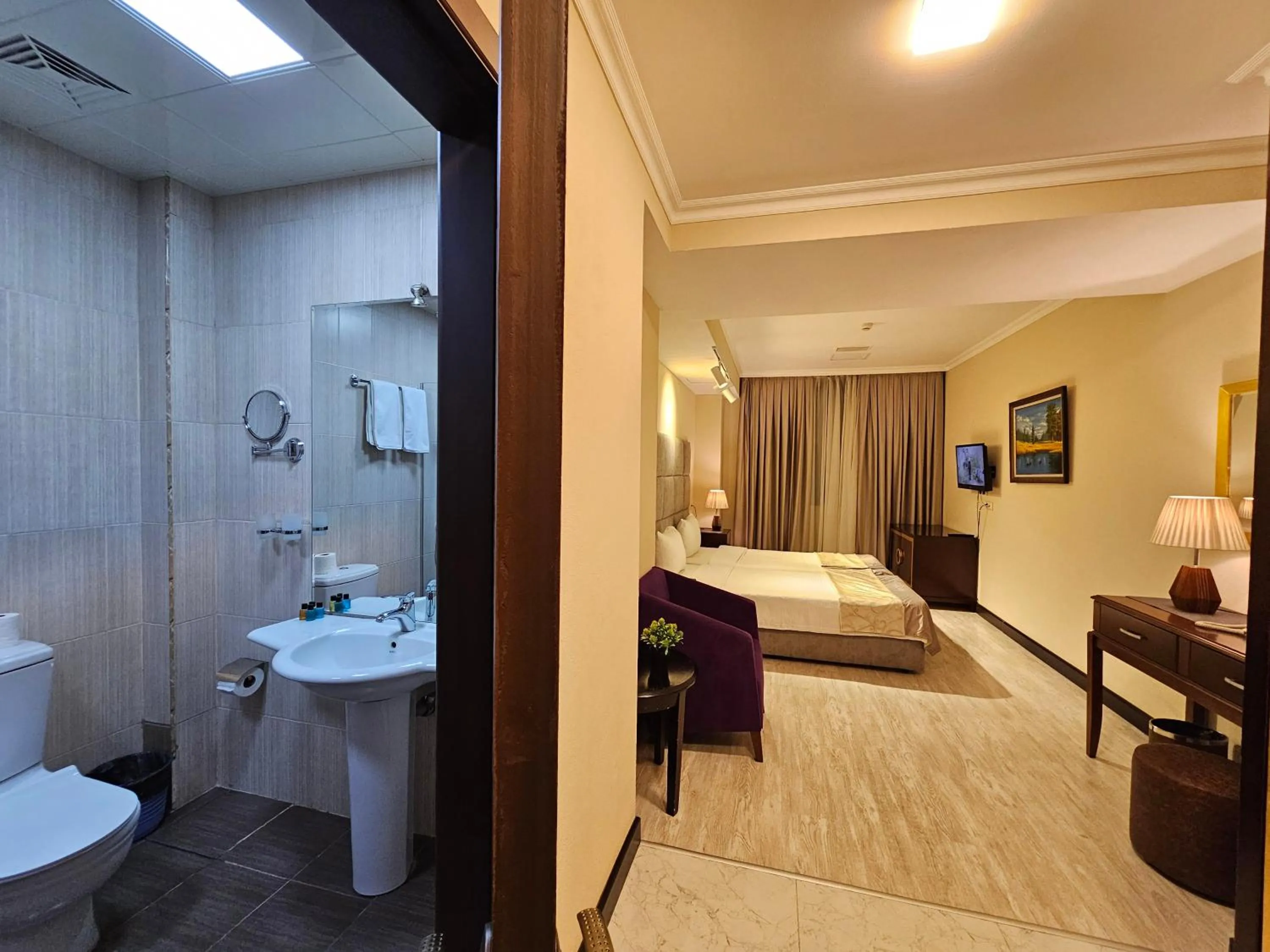 Toilet, Bed in Crown Suites Hotel