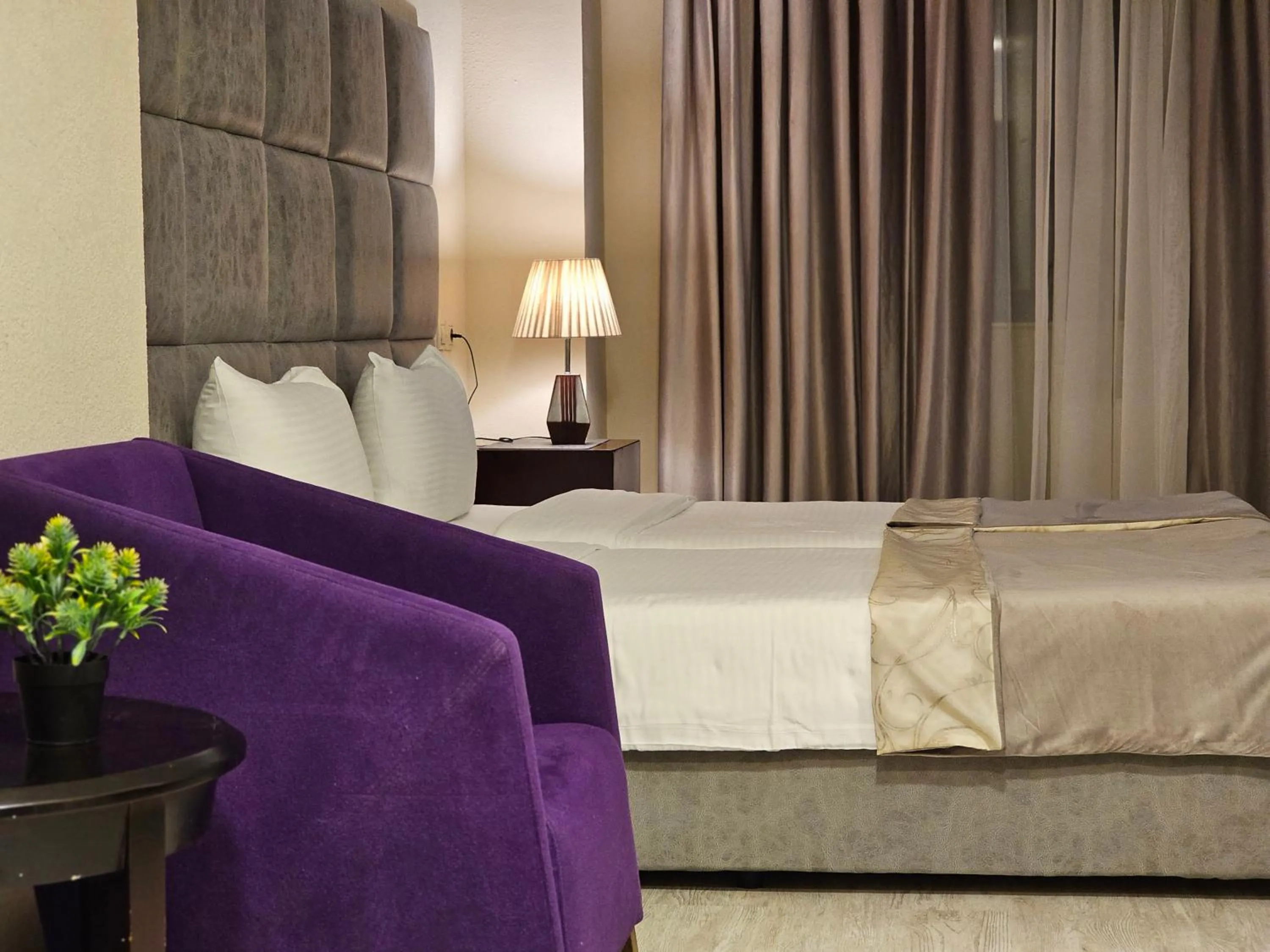 Bed in Crown Suites Hotel