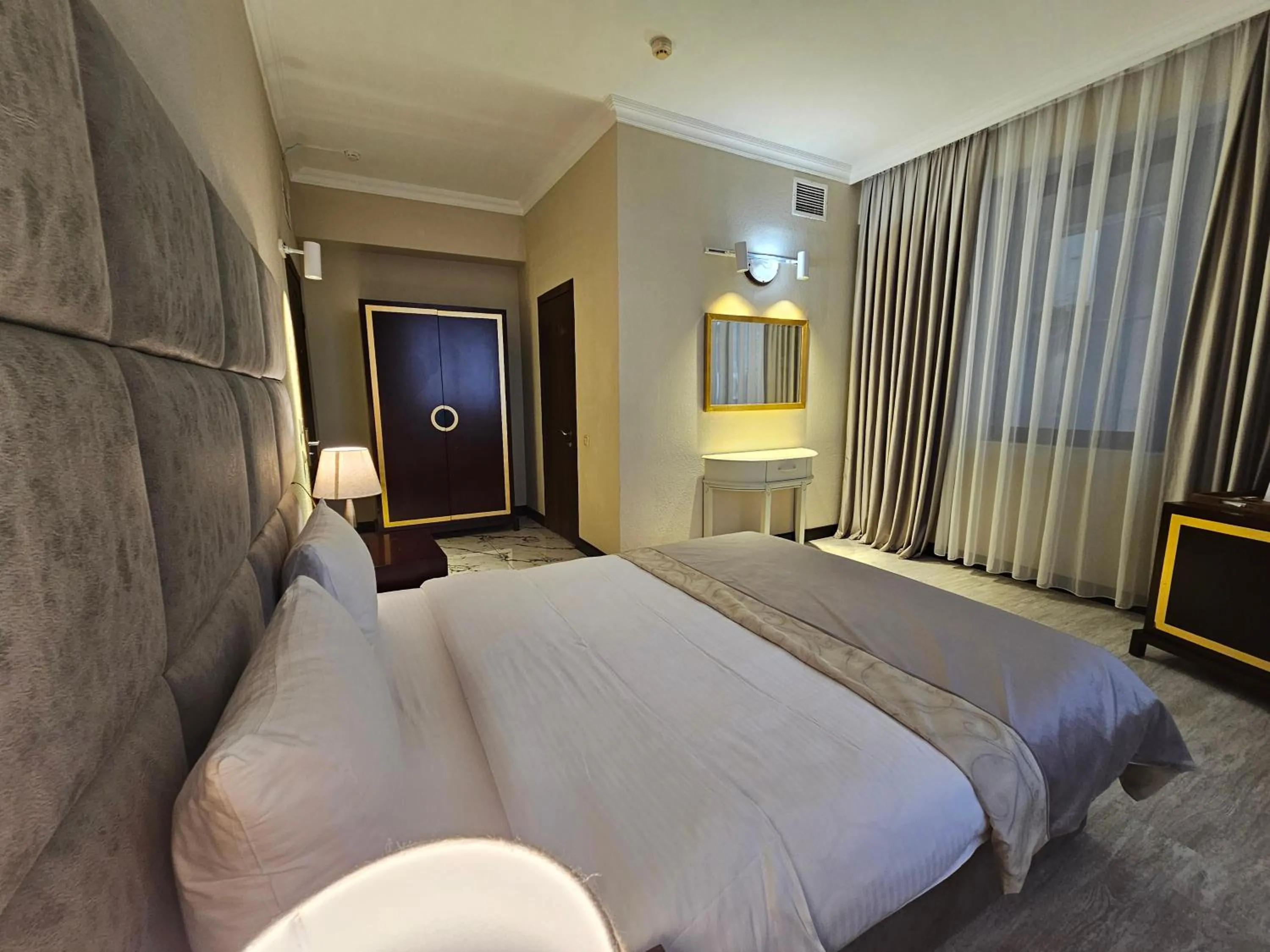 Bed in Crown Suites Hotel
