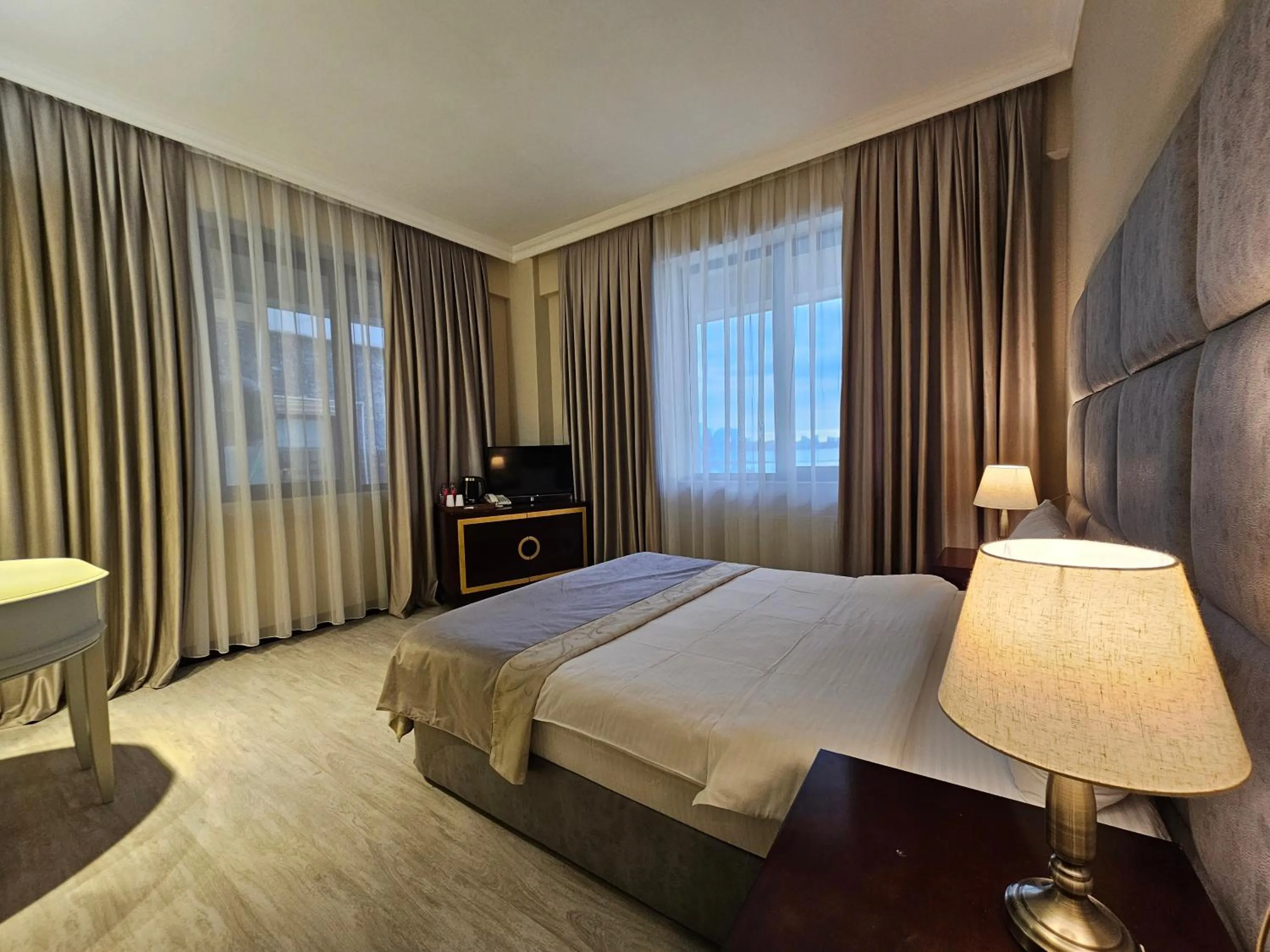 Bed in Crown Suites Hotel