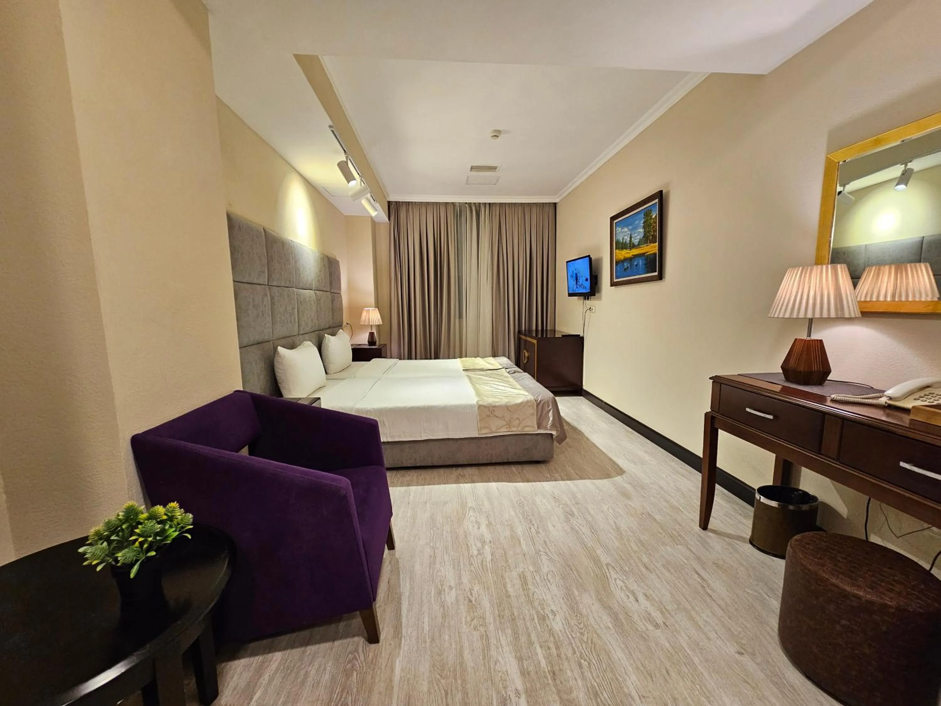 Bed in Crown Suites Hotel
