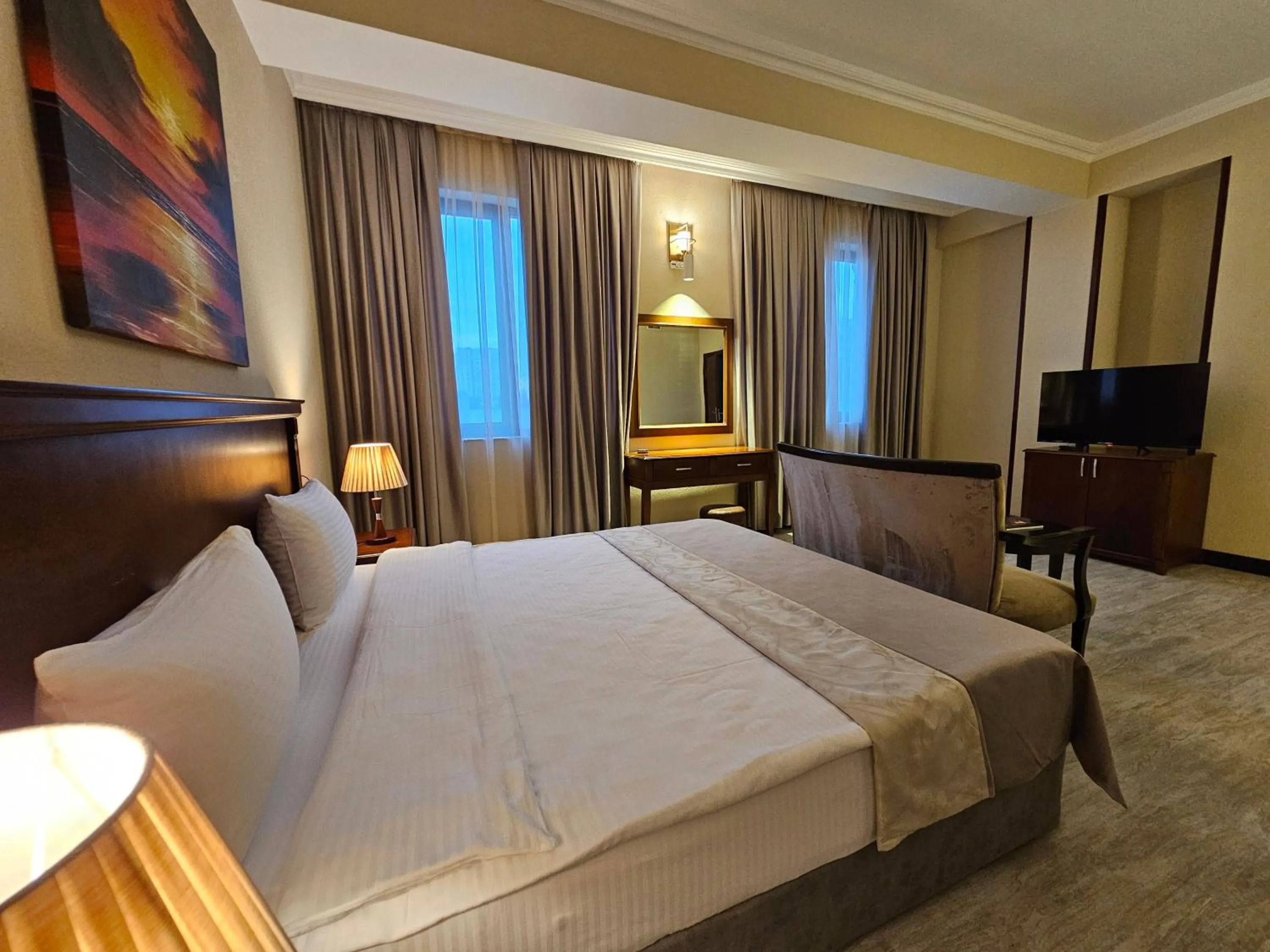 Bed in Crown Suites Hotel
