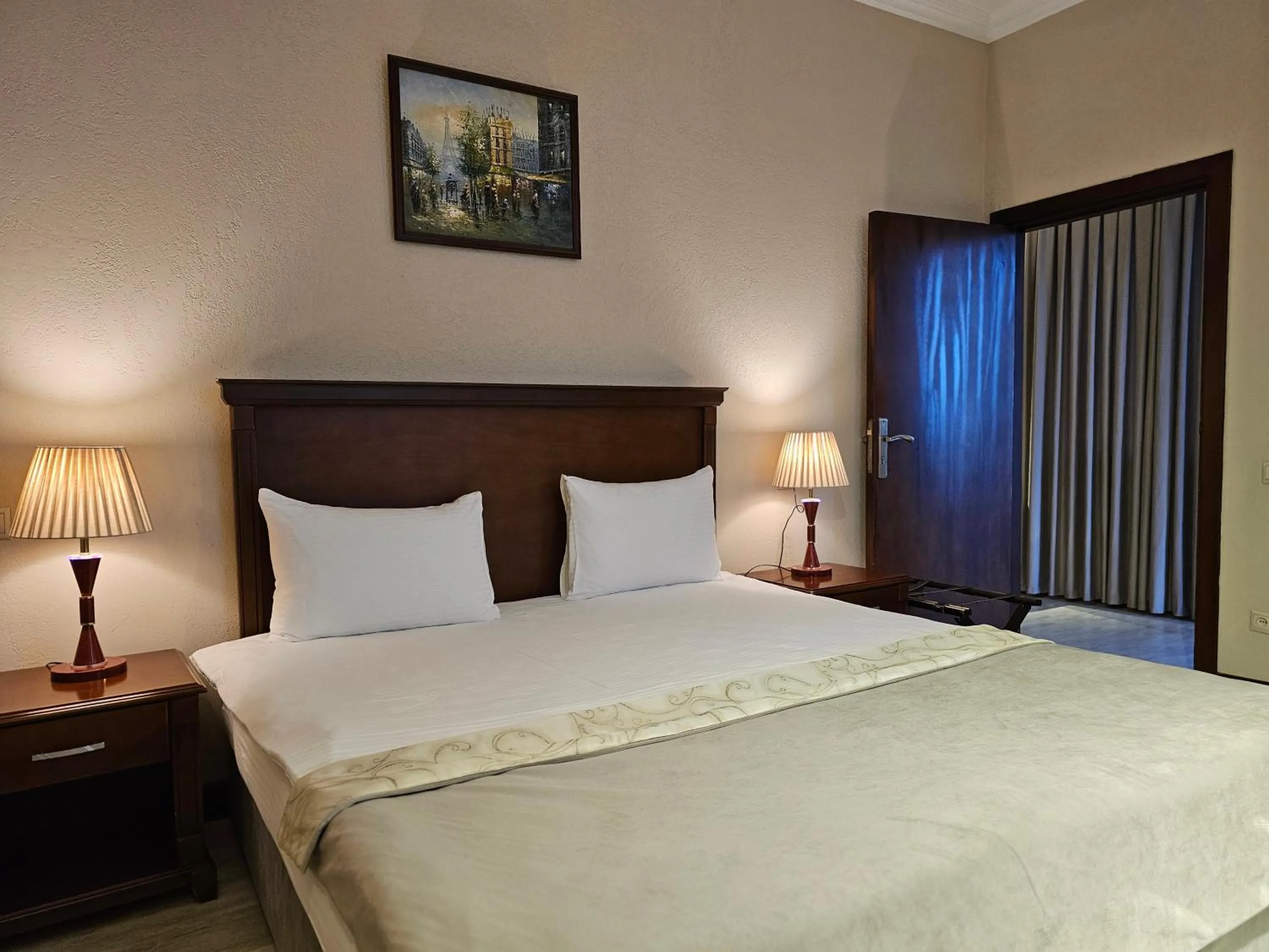 Bed in Crown Suites Hotel