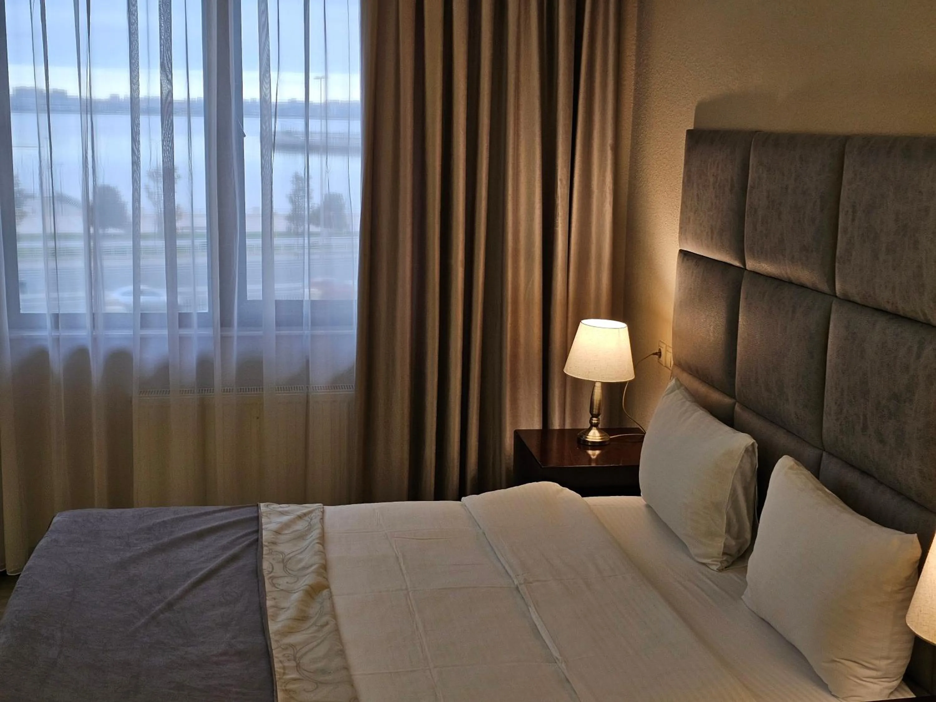 Bed in Crown Suites Hotel