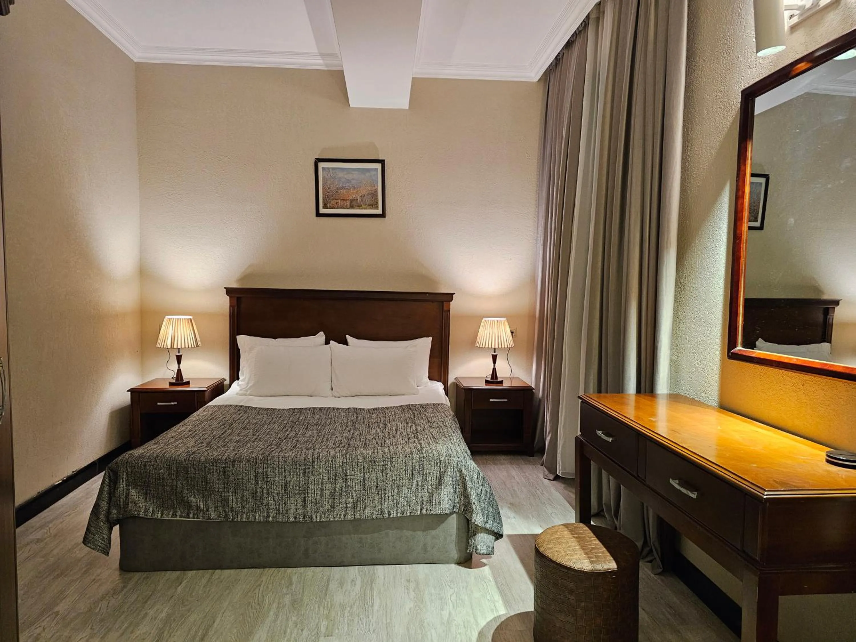Bed in Crown Suites Hotel