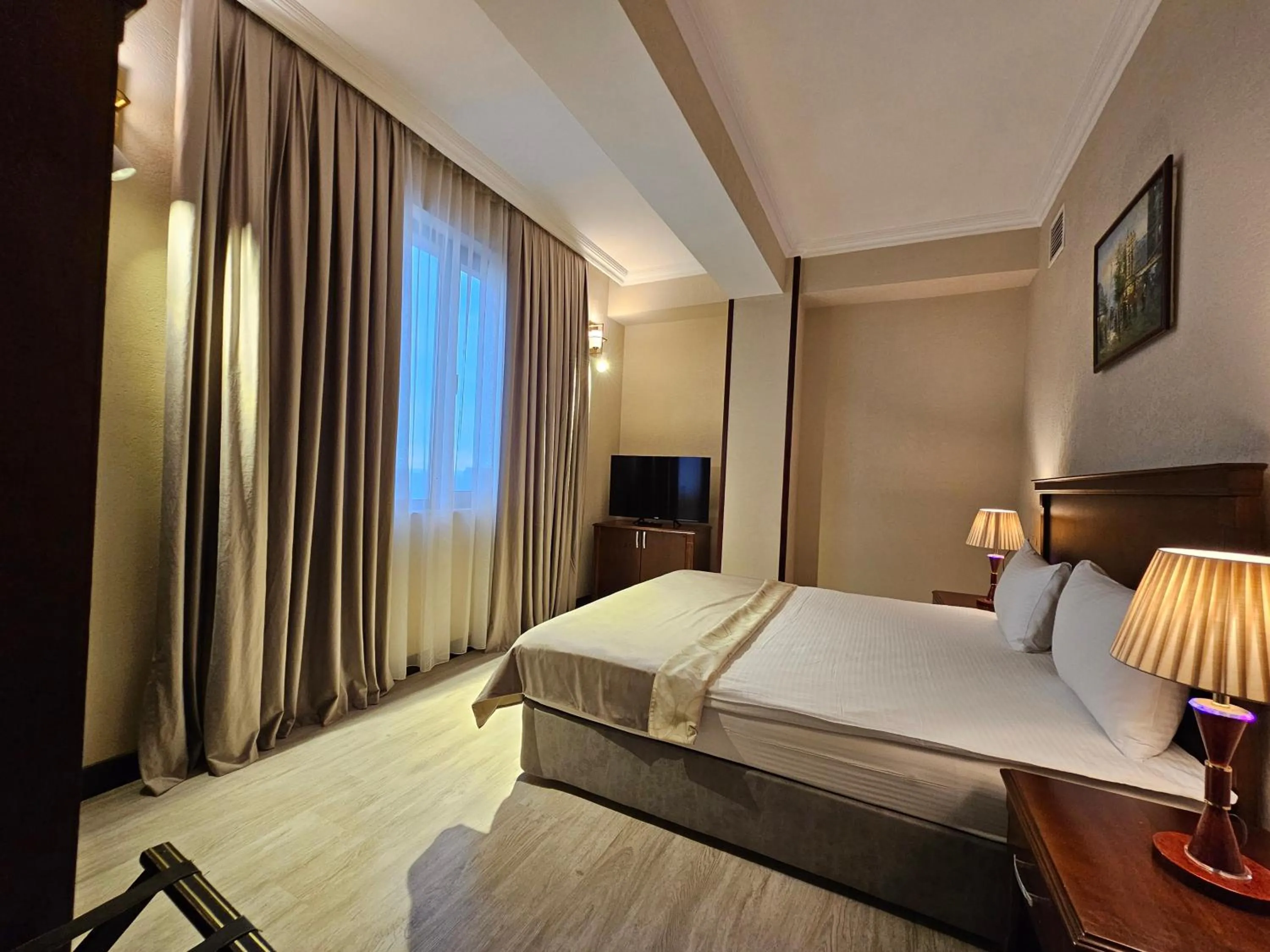 Bed in Crown Suites Hotel