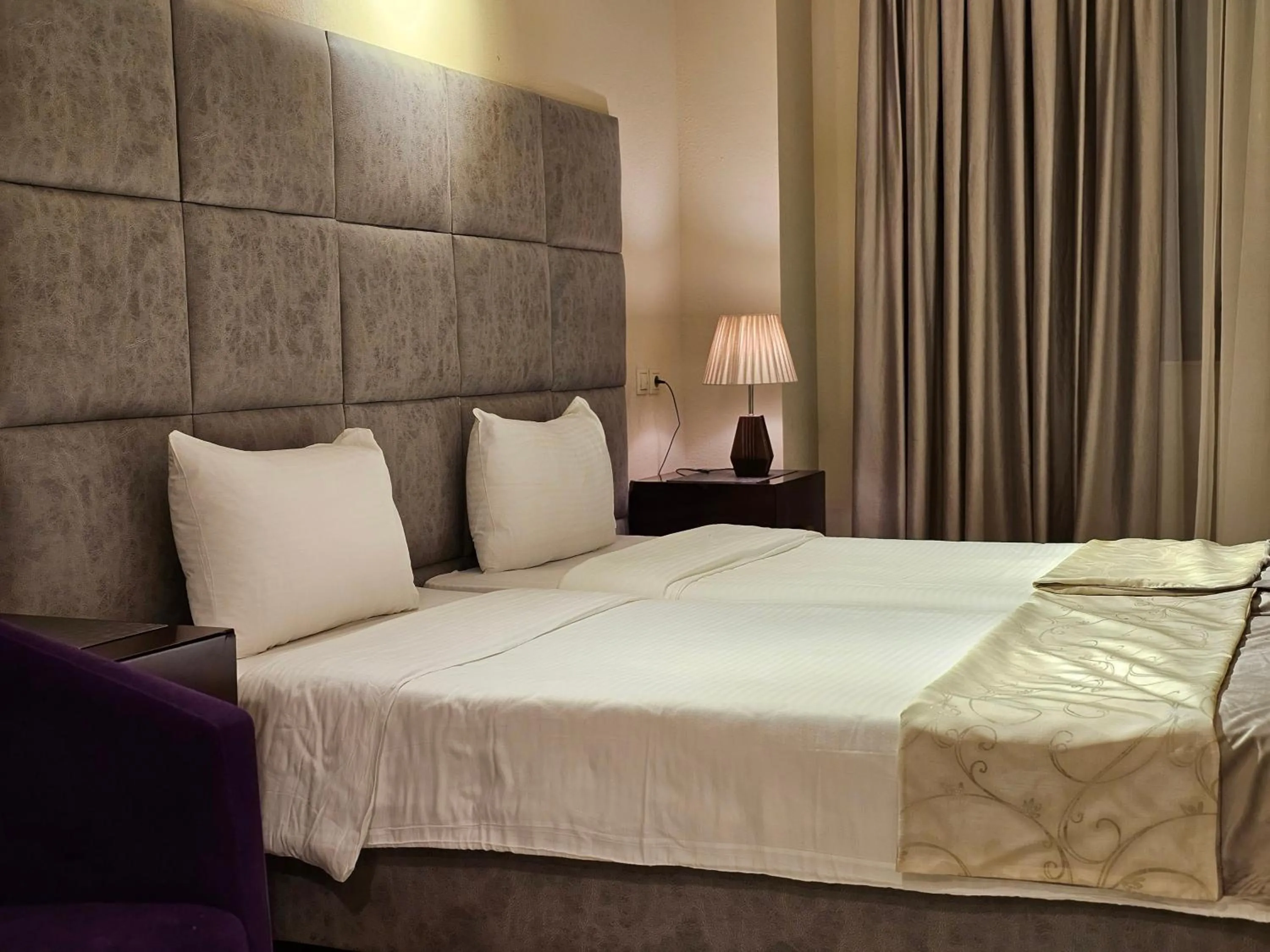 Bed in Crown Suites Hotel