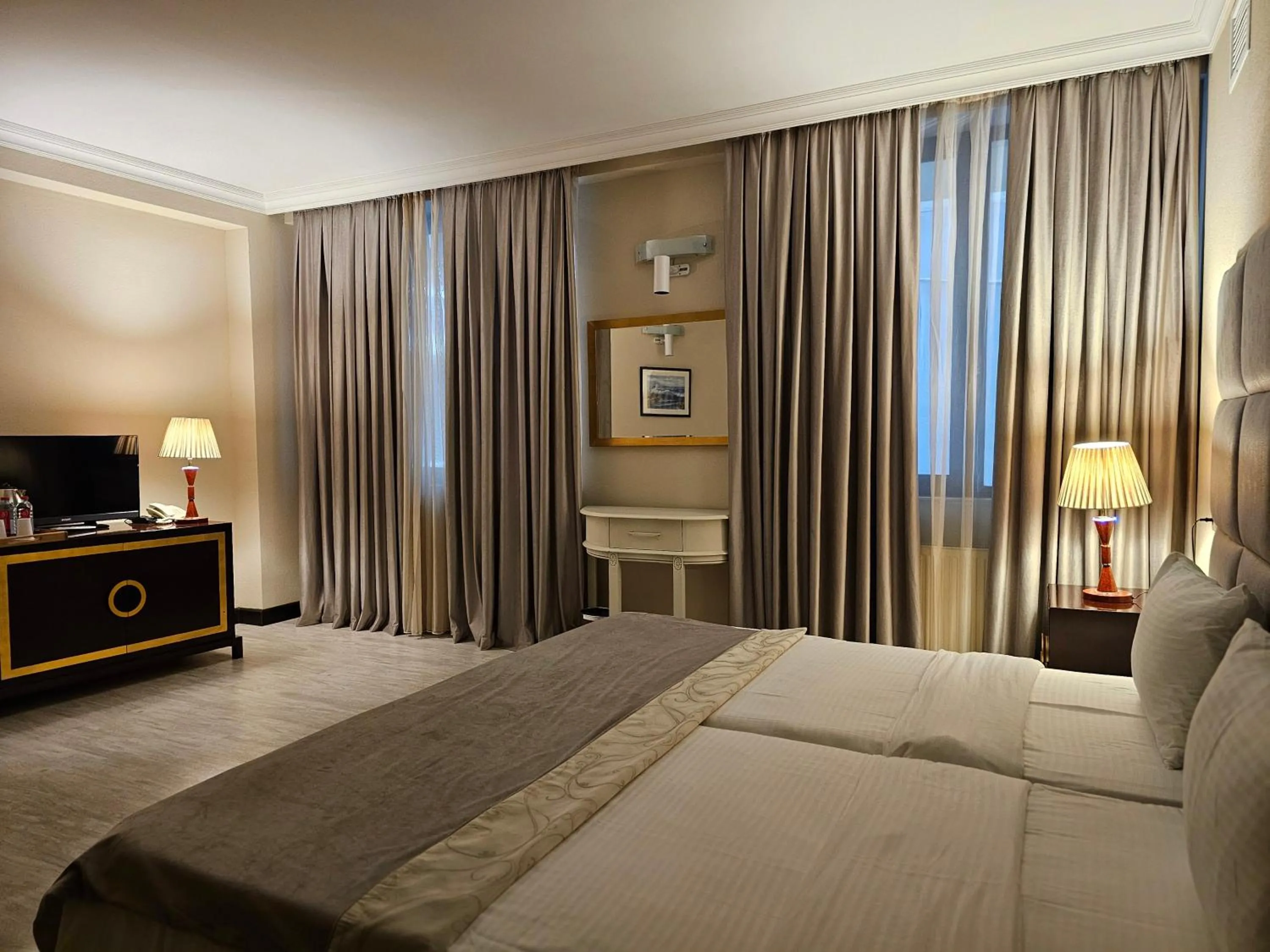 Bed in Crown Suites Hotel