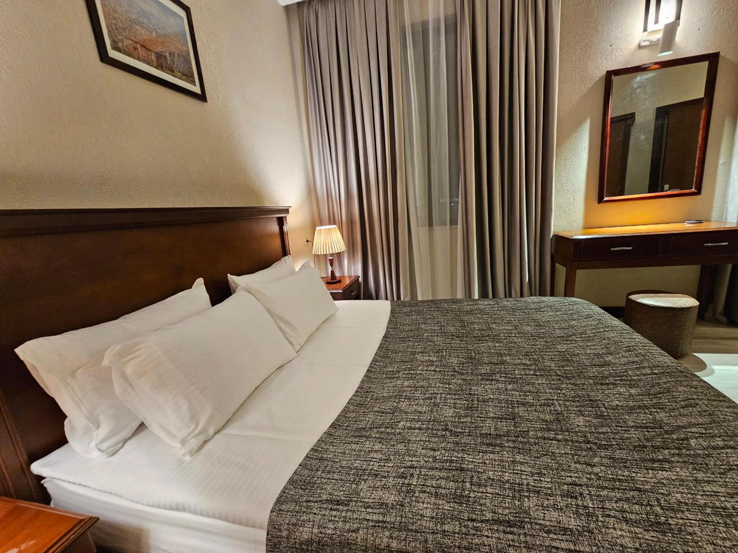 Bed in Crown Suites Hotel