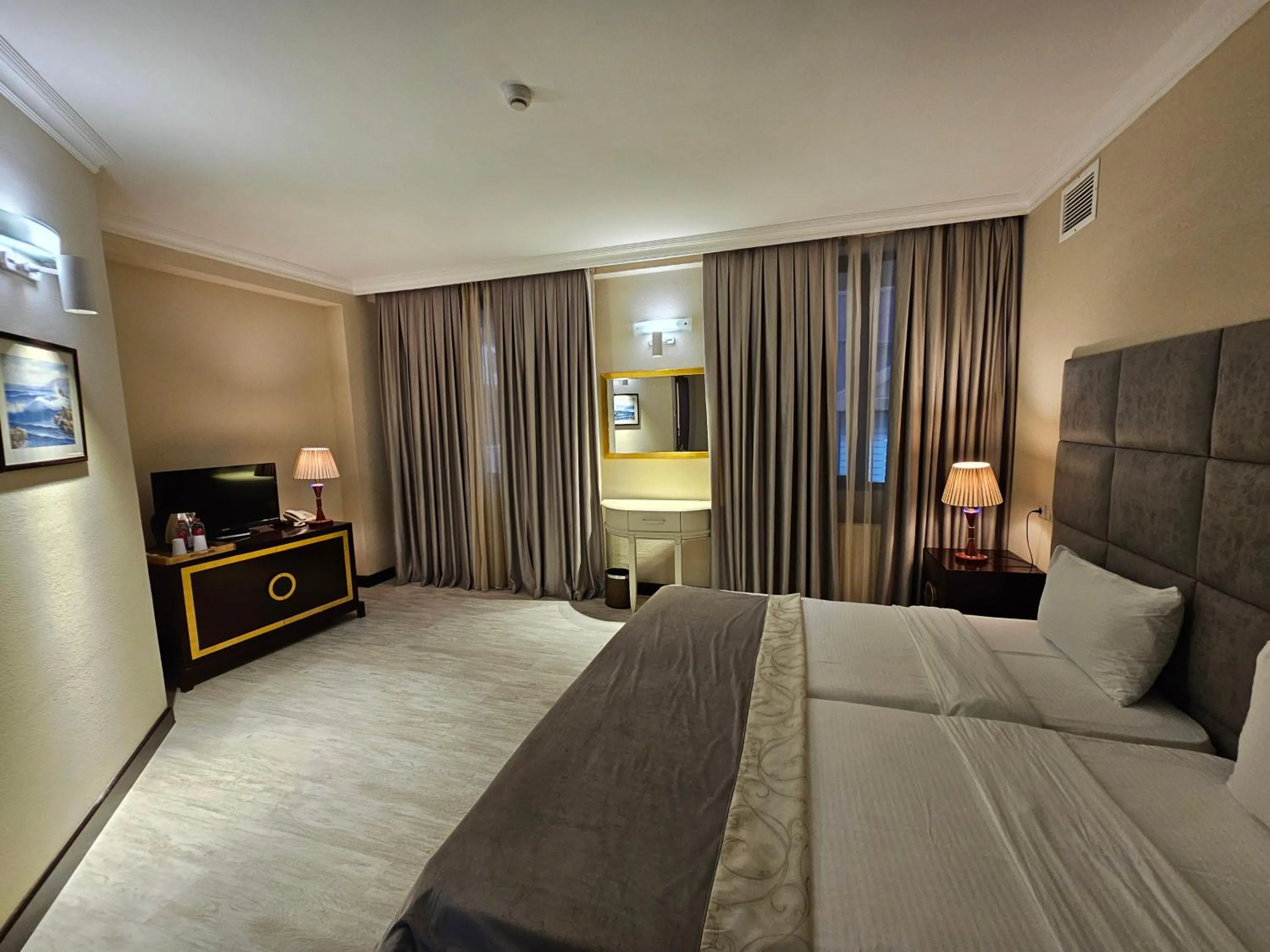 Bed in Crown Suites Hotel