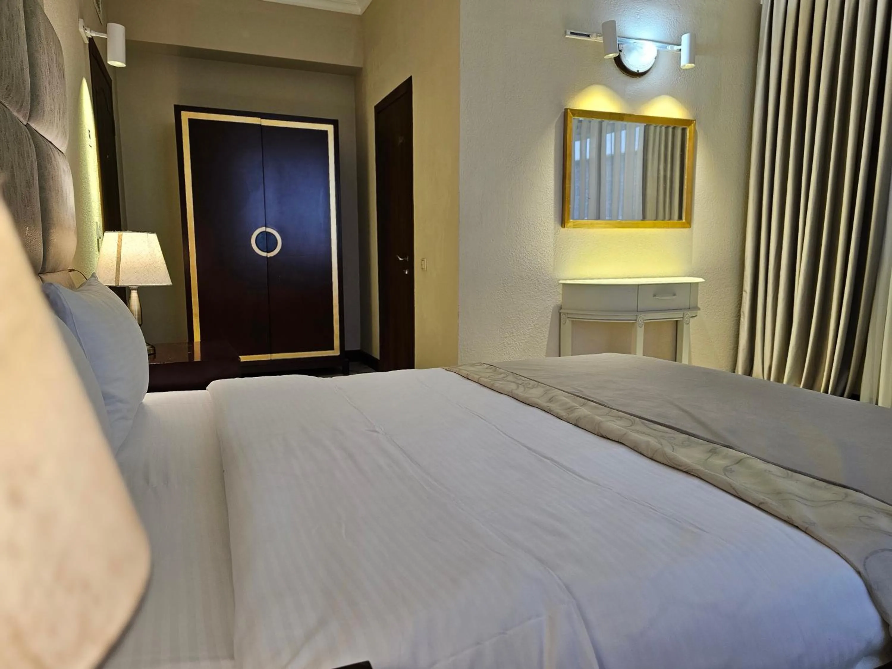 Bed in Crown Suites Hotel