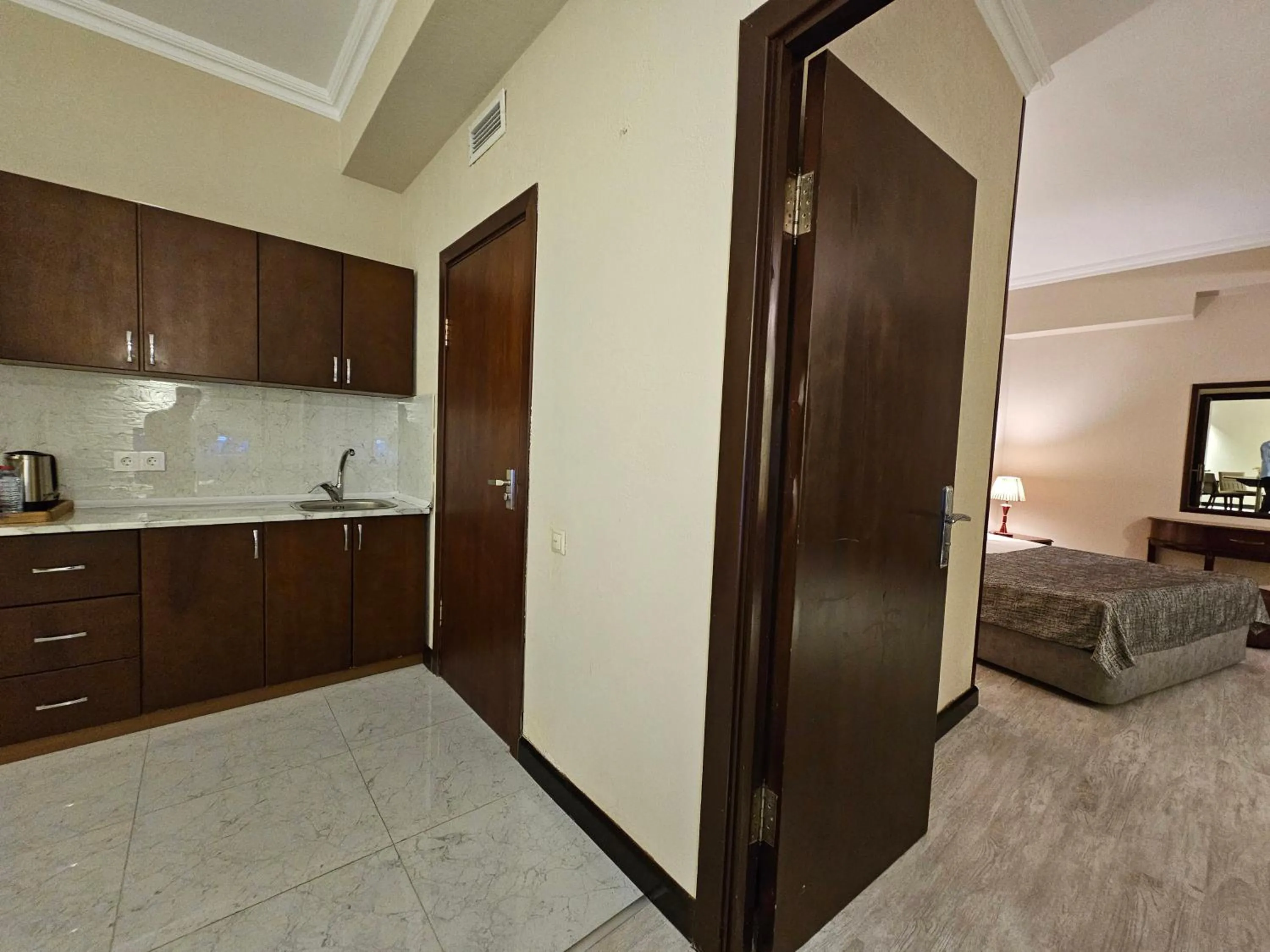 Bed in Crown Suites Hotel