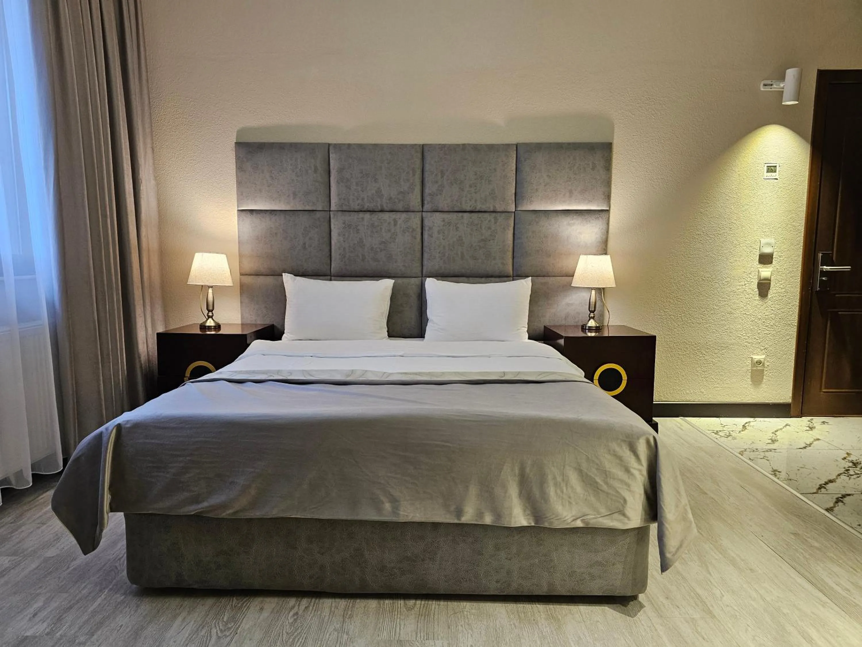 Bed in Crown Suites Hotel