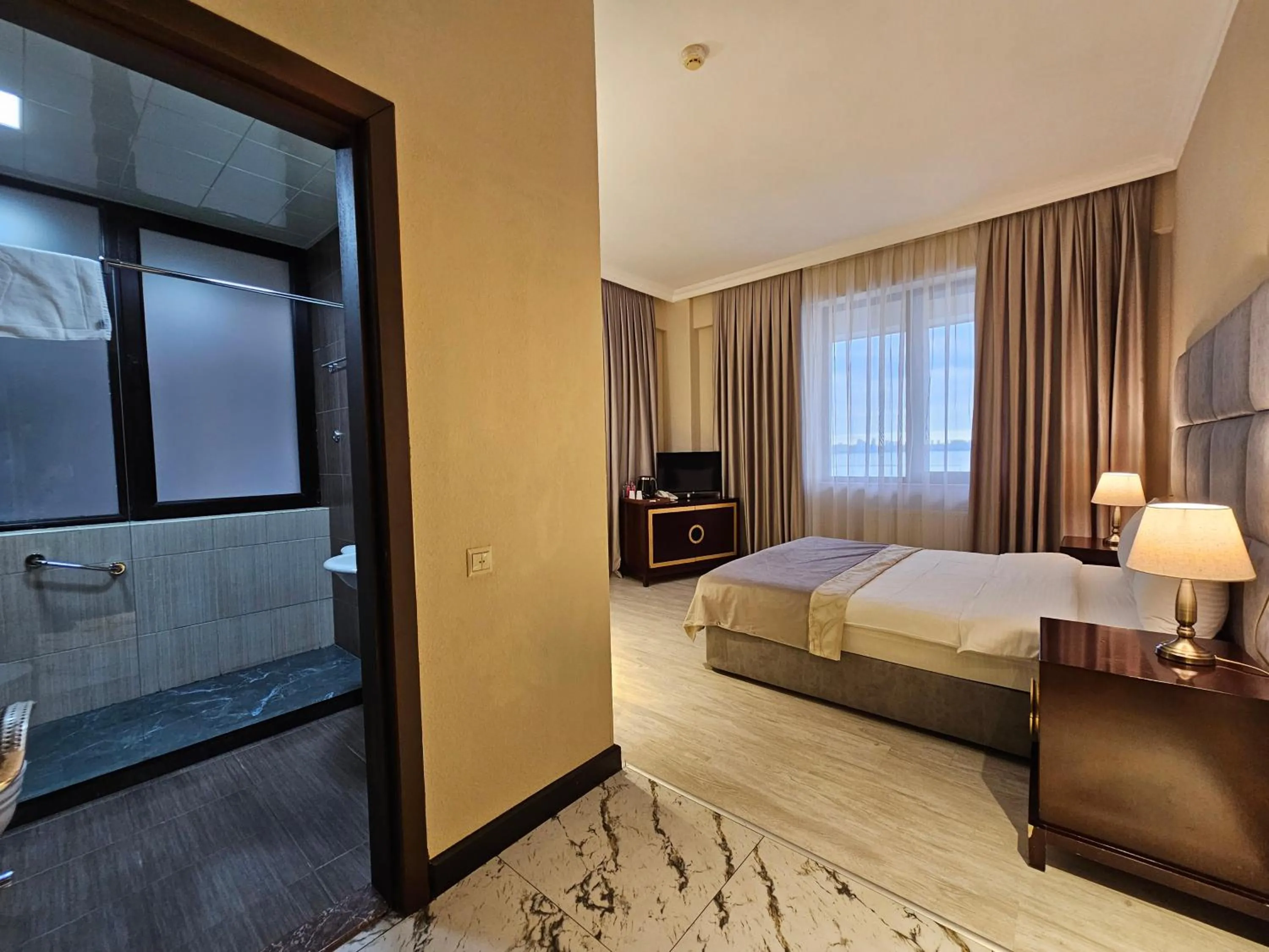 Bed in Crown Suites Hotel