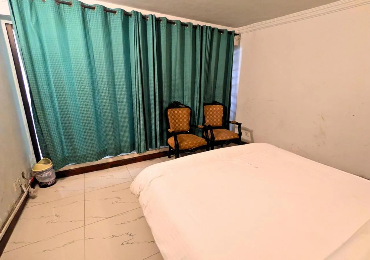 Seating area, Bed in Grand Heights Hotel