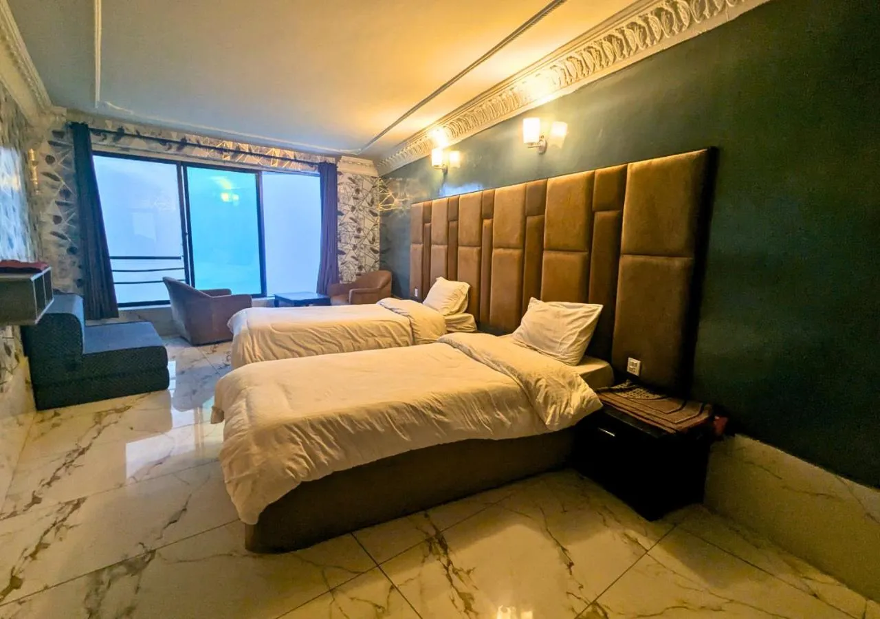 Seating area, Bed in Grand Heights Hotel