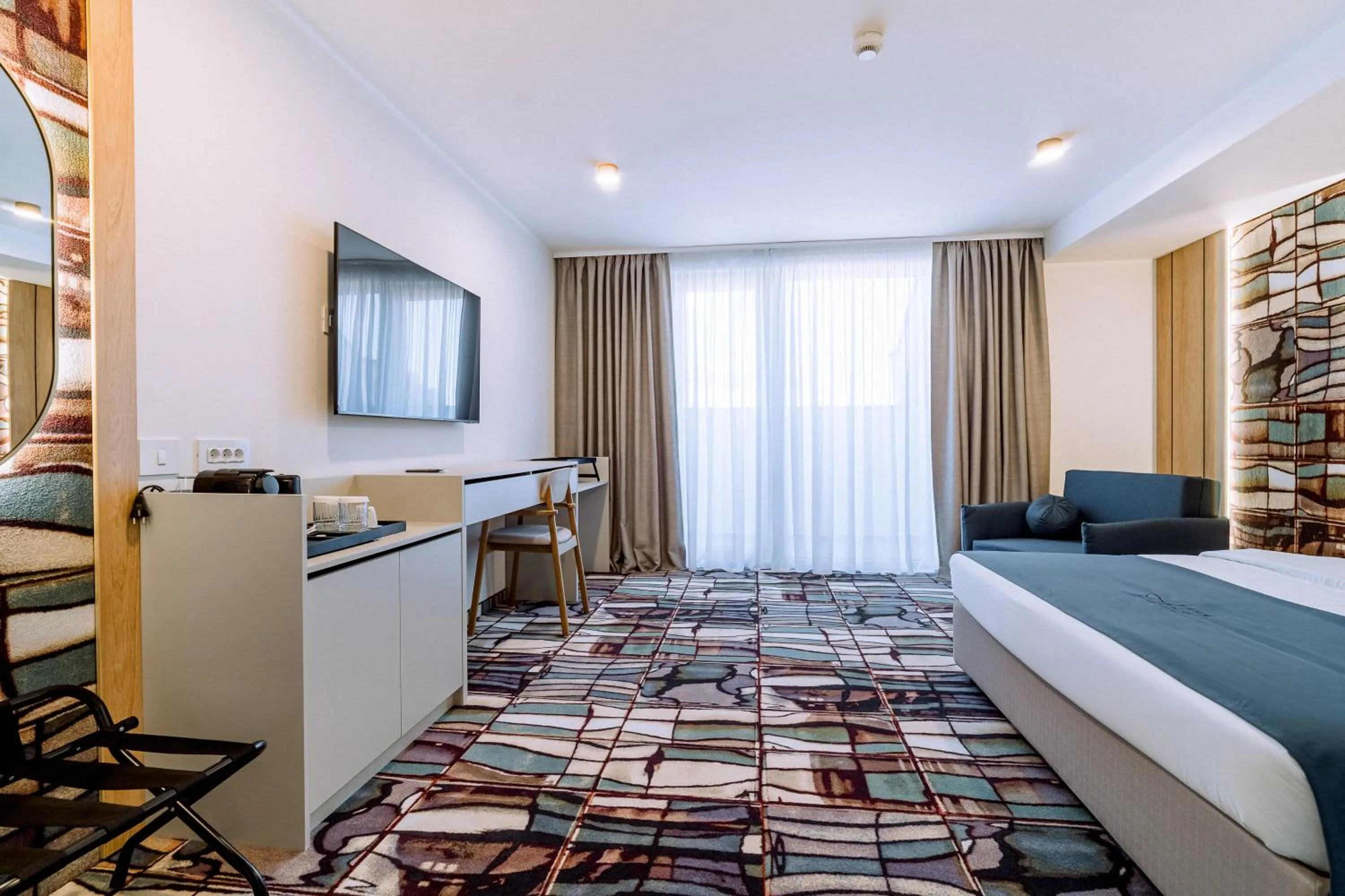 Communal lounge/ TV room, Bed in ARIS Boutique Hotel & SPA