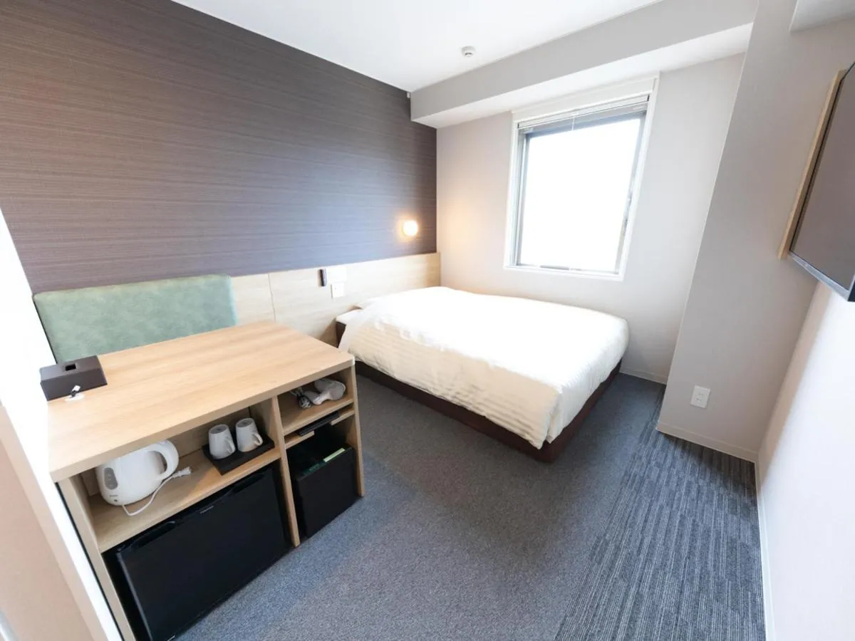 Bed in Super Hotel Premier Aso Kumamoto Airport