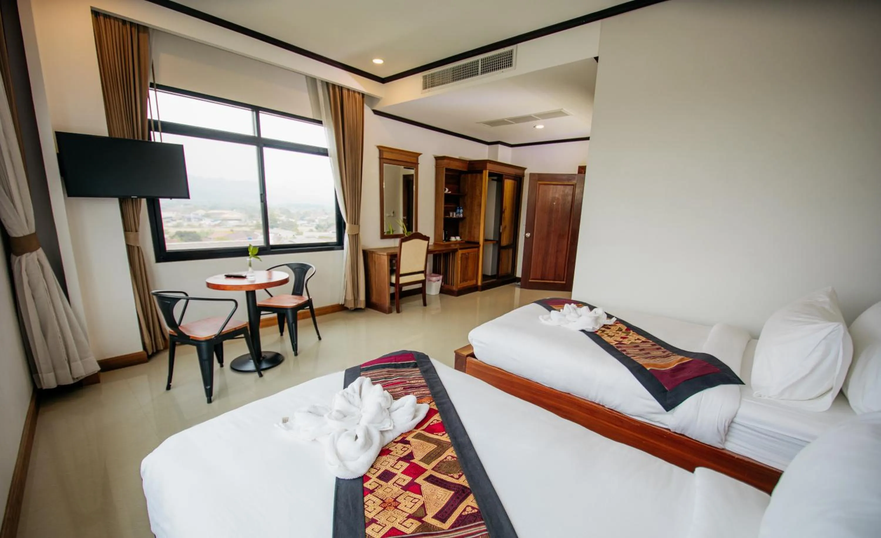 Bed in Sisombat Plaza Hotel