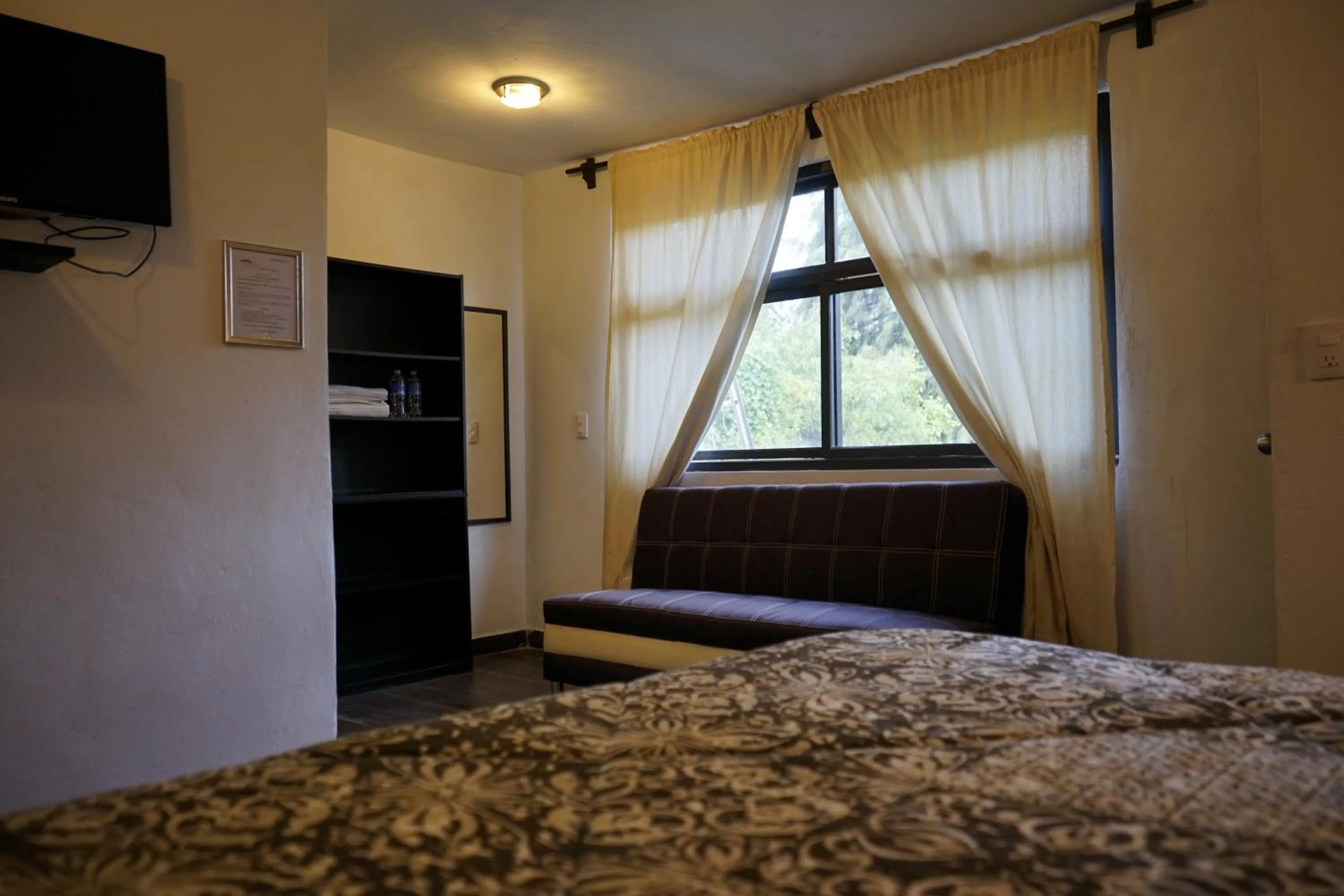 Bed in Telpochcalli Hotel & Temazcal