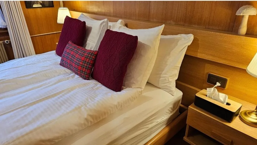 Photo of the whole room, Bed in Alpina Boutique Hotel Interlaken - Ringgenberg - Adults only !