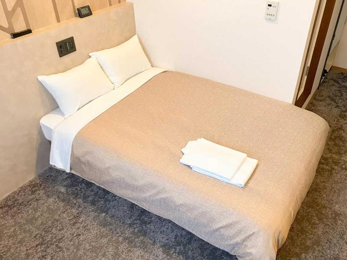 Bed in Hotel LiVEMAX Tendo
