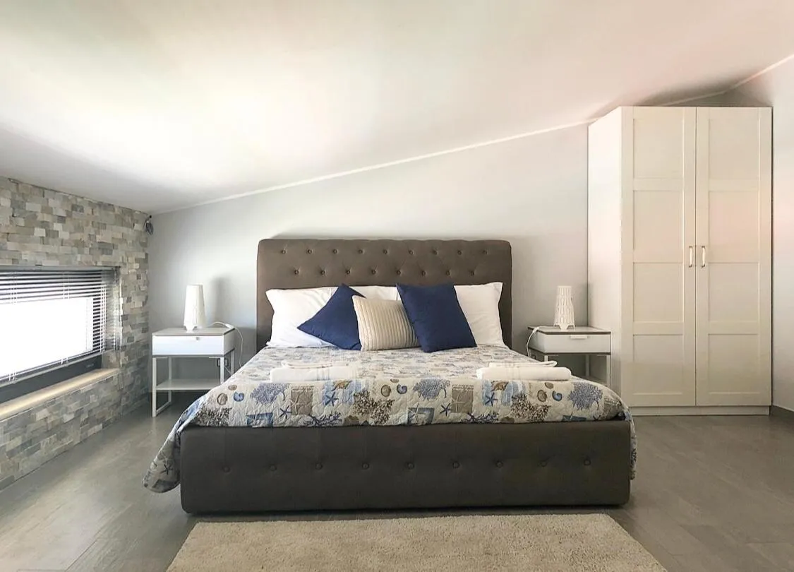 Bed in Pietra Bianca Rooms