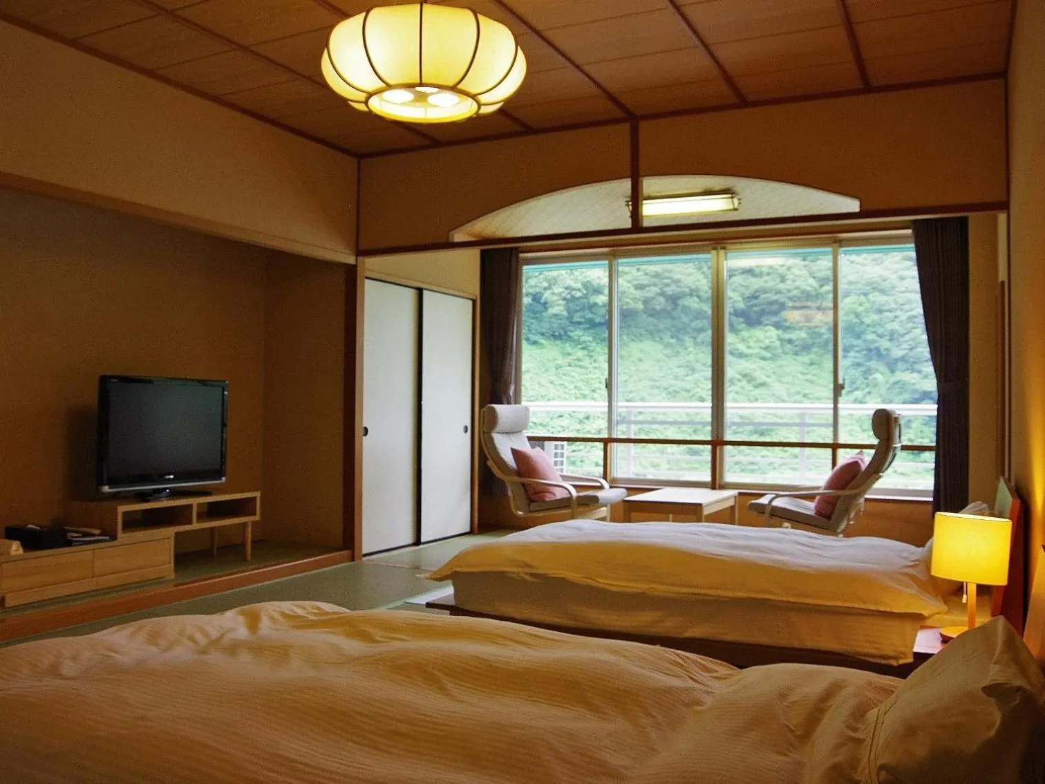 Bed in Hotel Kunitomi Suisennkaku